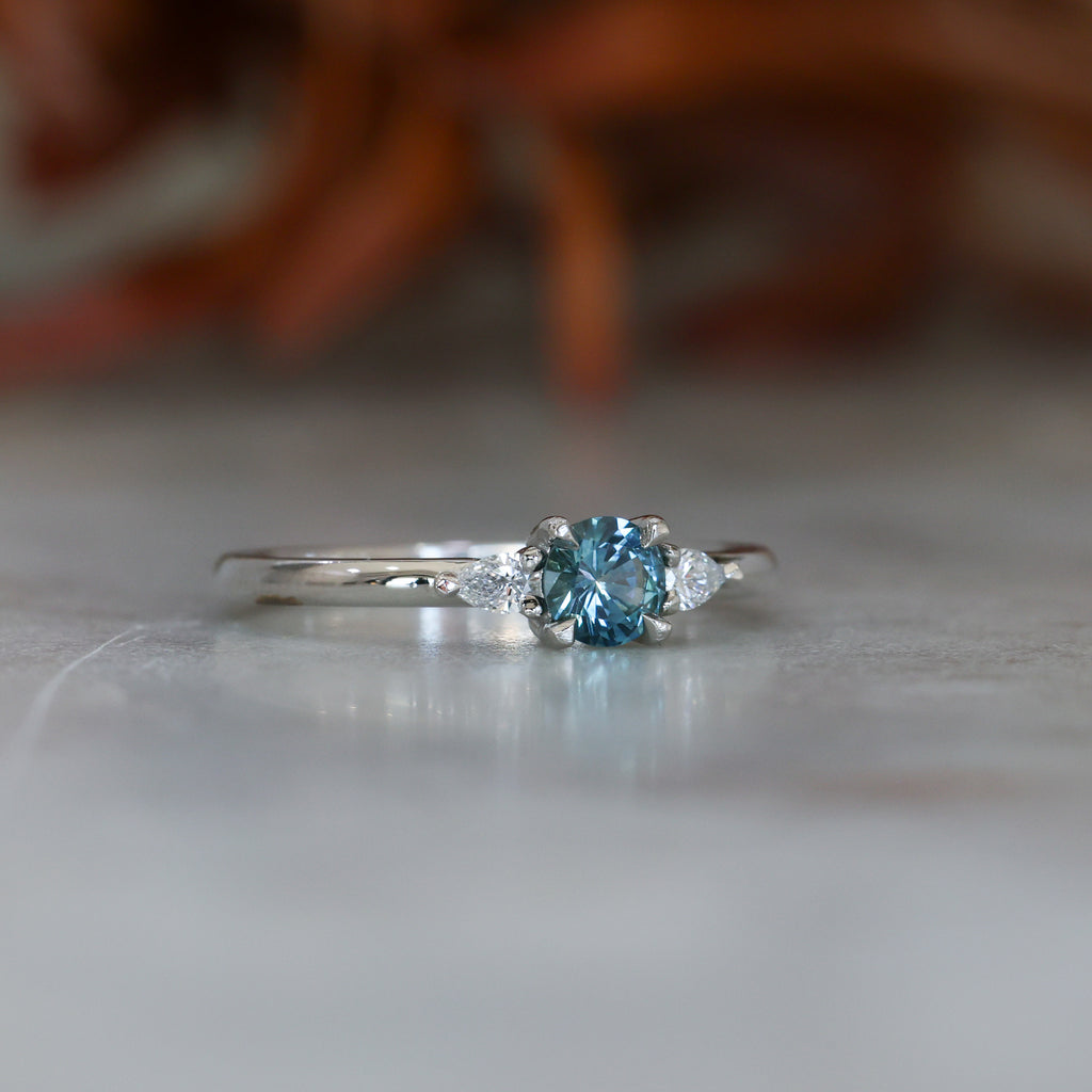 0.37ct Round Cut Montana Sapphire and Pear Diamond Engagement ring in platinum band