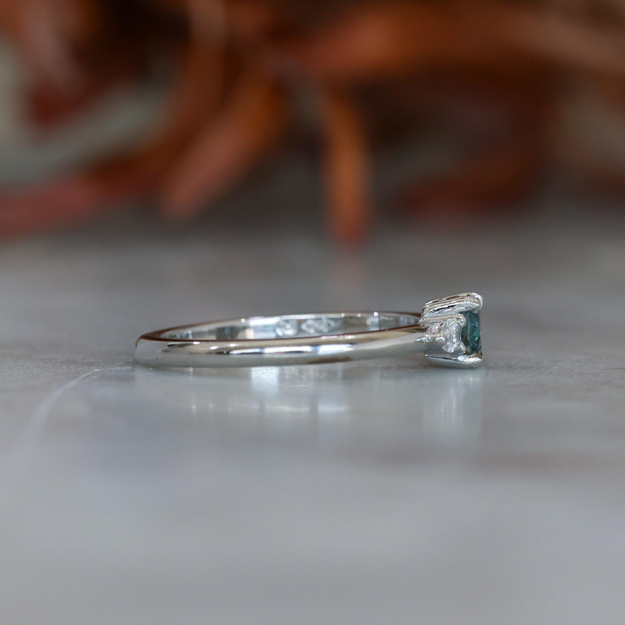 0.37ct Round Cut Montana Sapphire and Pear Diamond Engagement ring in platinum band