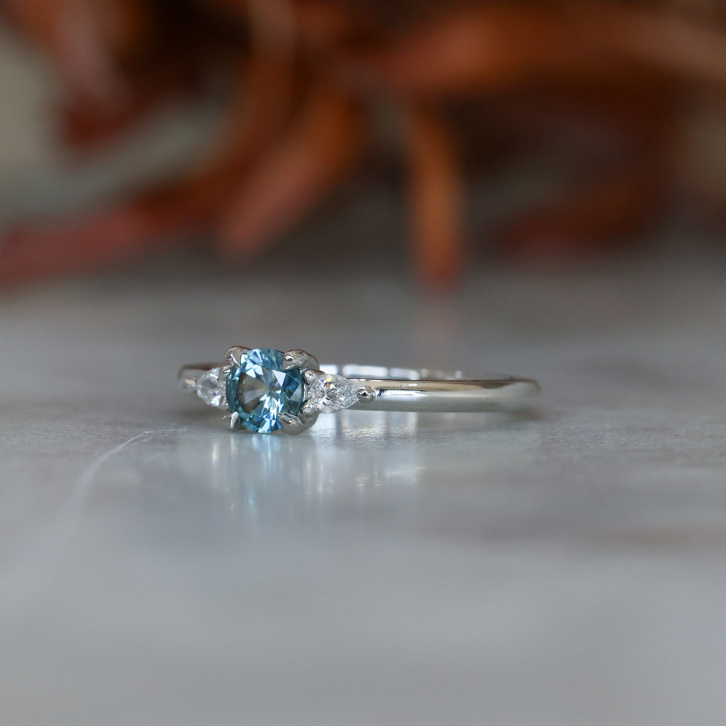 0.37ct Round Cut Montana Sapphire and Pear Diamond Engagement ring in platinum band