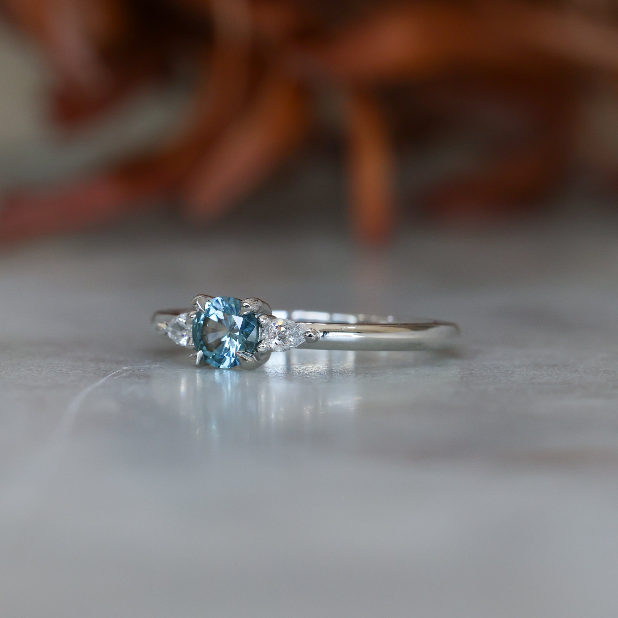 0.37ct Round Cut Montana Sapphire and Pear Diamond Engagement ring in platinum band