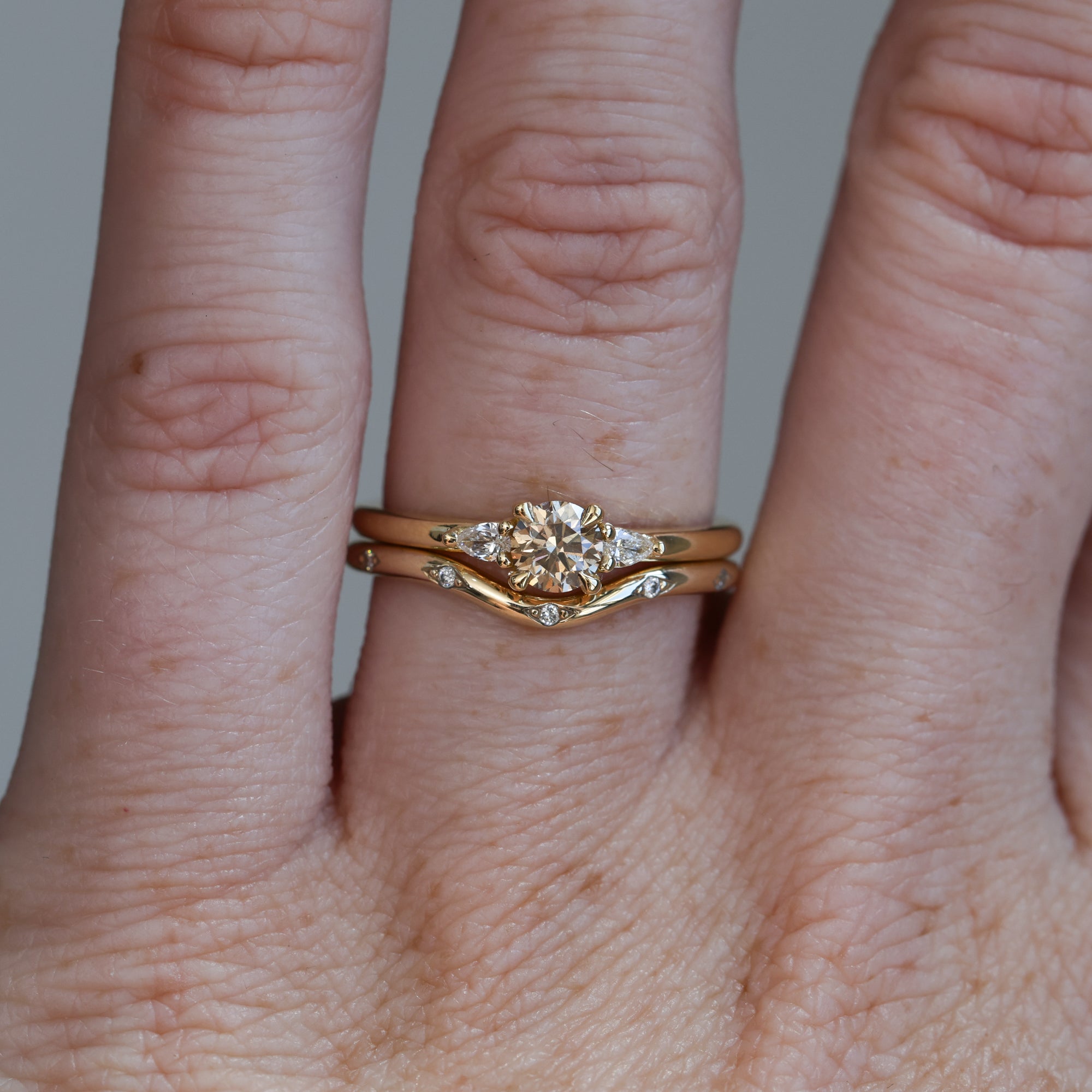 0.38ct Champagne Diamond Trilogy Engagement ring on hand with wedding band