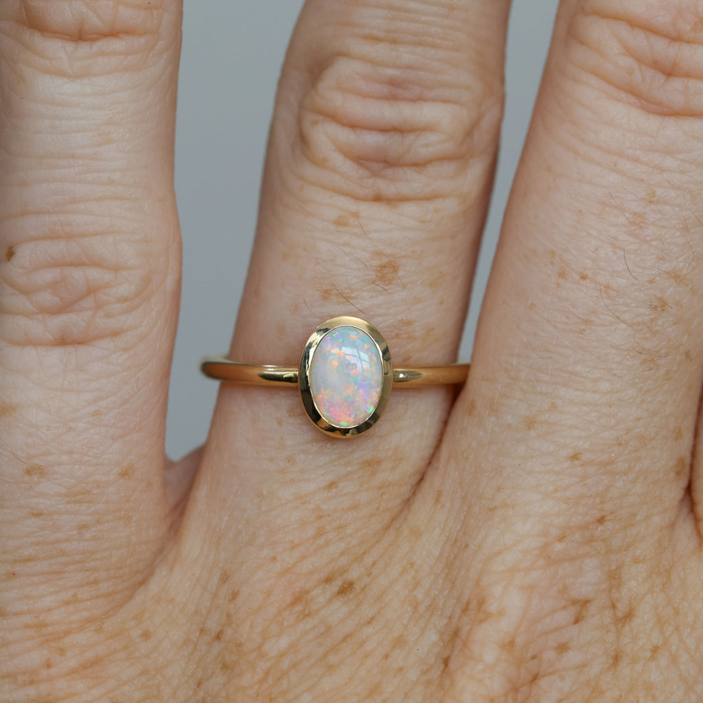 0.43ct opal bezel ring on hand