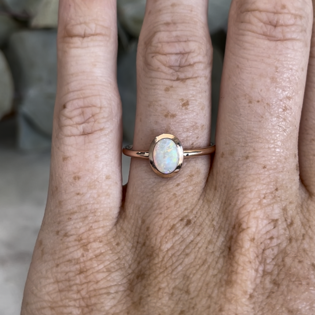 0.46ct oval cut Australian Opal ring on hand