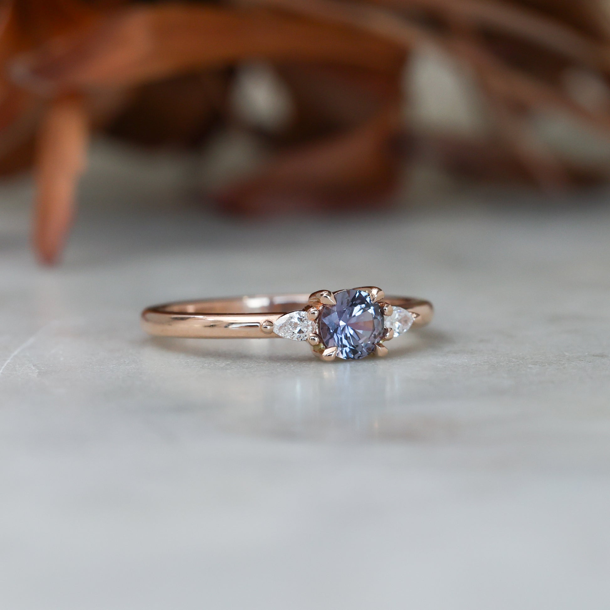 0.47ct Montana Sapphire trilogy engagement ring side view rose gold band