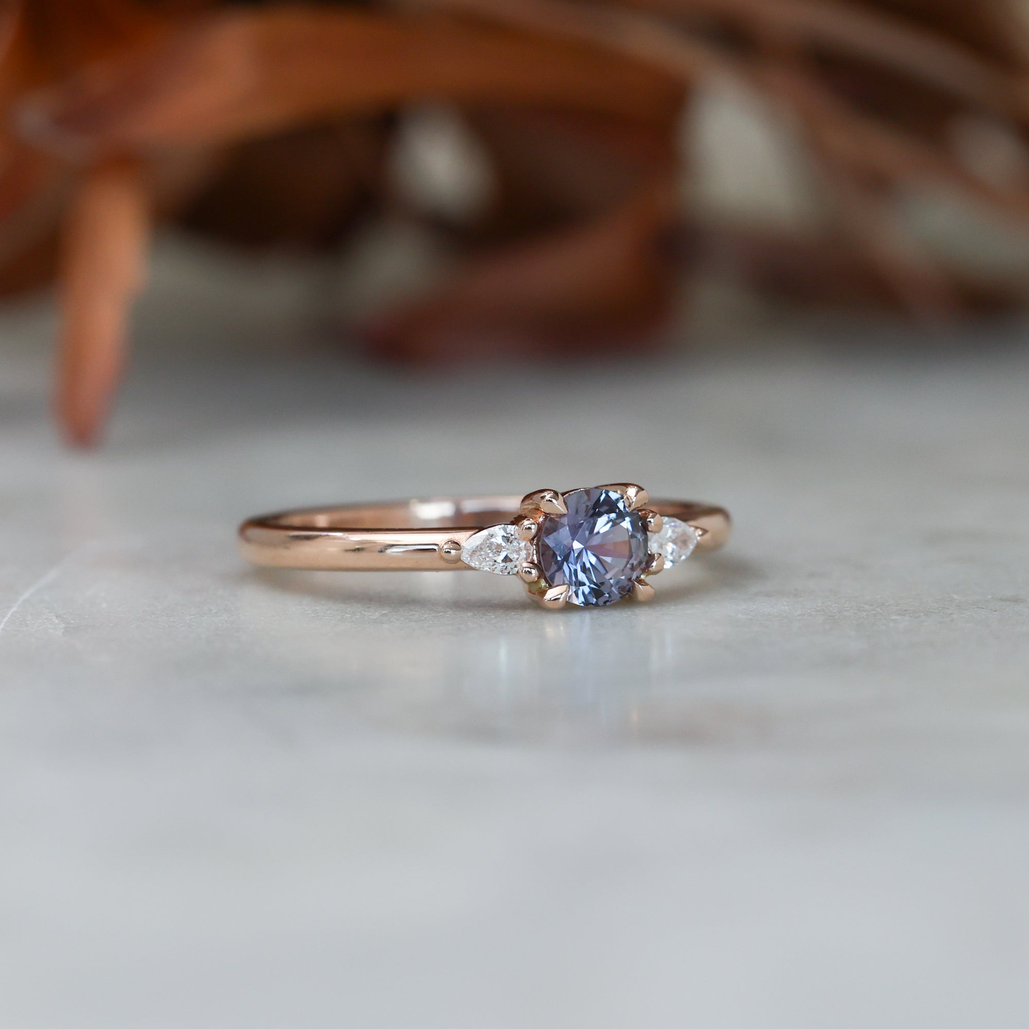 0.47ct Montana Sapphire trilogy engagement ring side view rose gold band