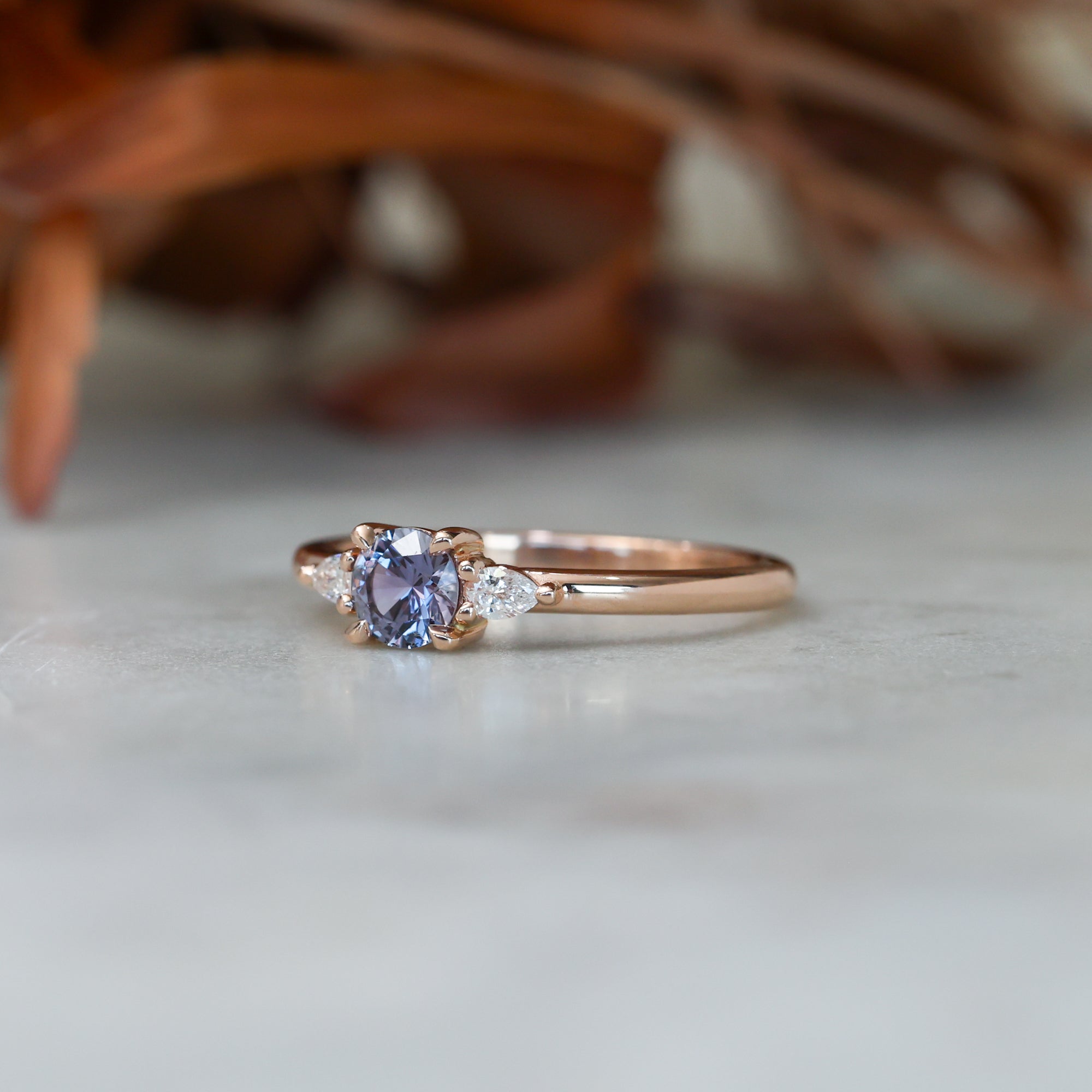 0.47ct Purple Montana Sapphire trilogy engagement ring with rose gold band