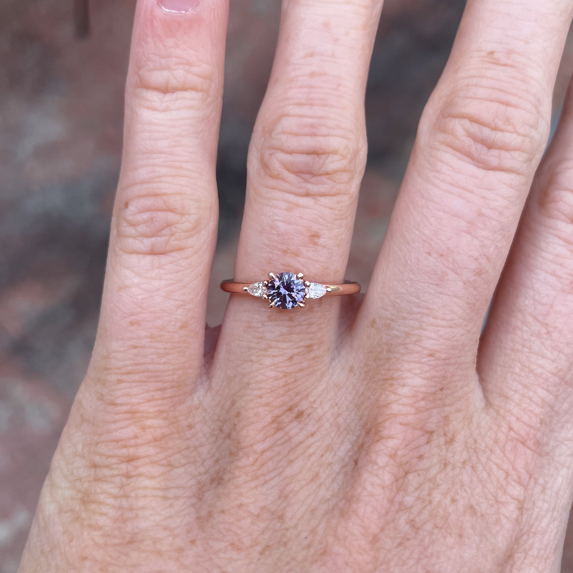 0.47ct Montana Sapphire trilogy engagement ring on hand