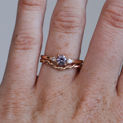 0.47ct Purple Montana Sapphire trilogy engagement ring on hand with wedding band