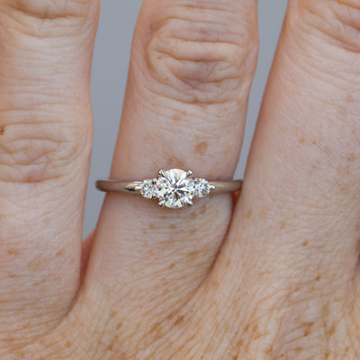 0.50ct round cut lunar trilogy engagement ring in platinum on hand