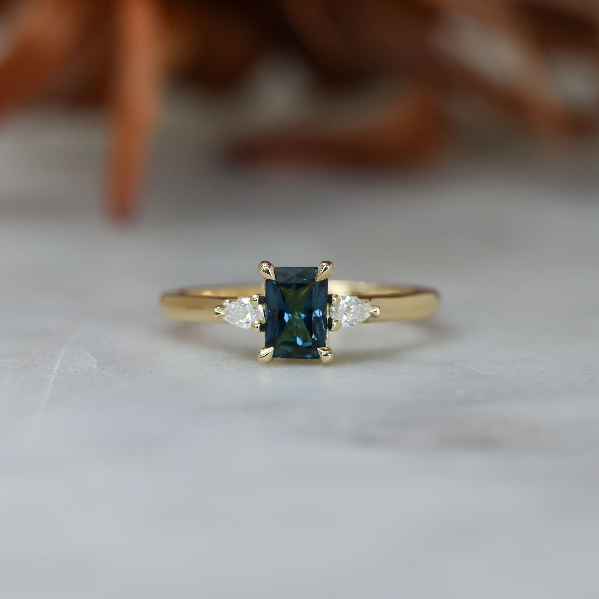 0.66ct Emerald cut australian sapphire trilogy engagement ring