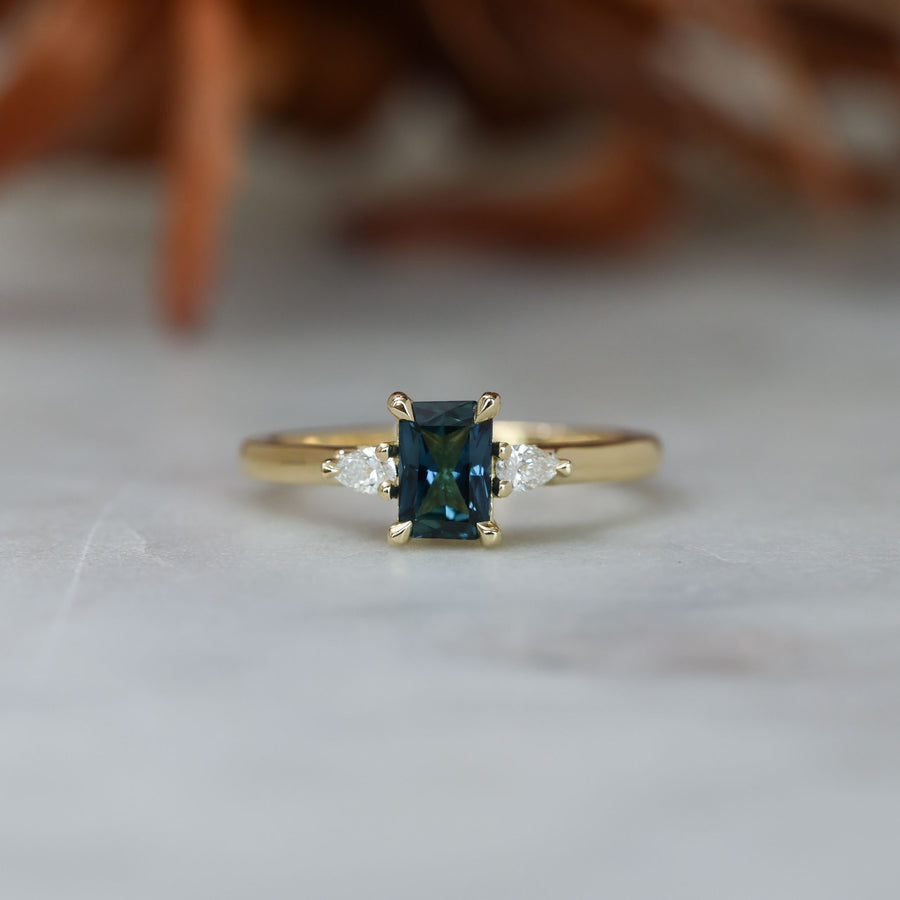 0.66ct Emerald cut australian sapphire trilogy engagement ring