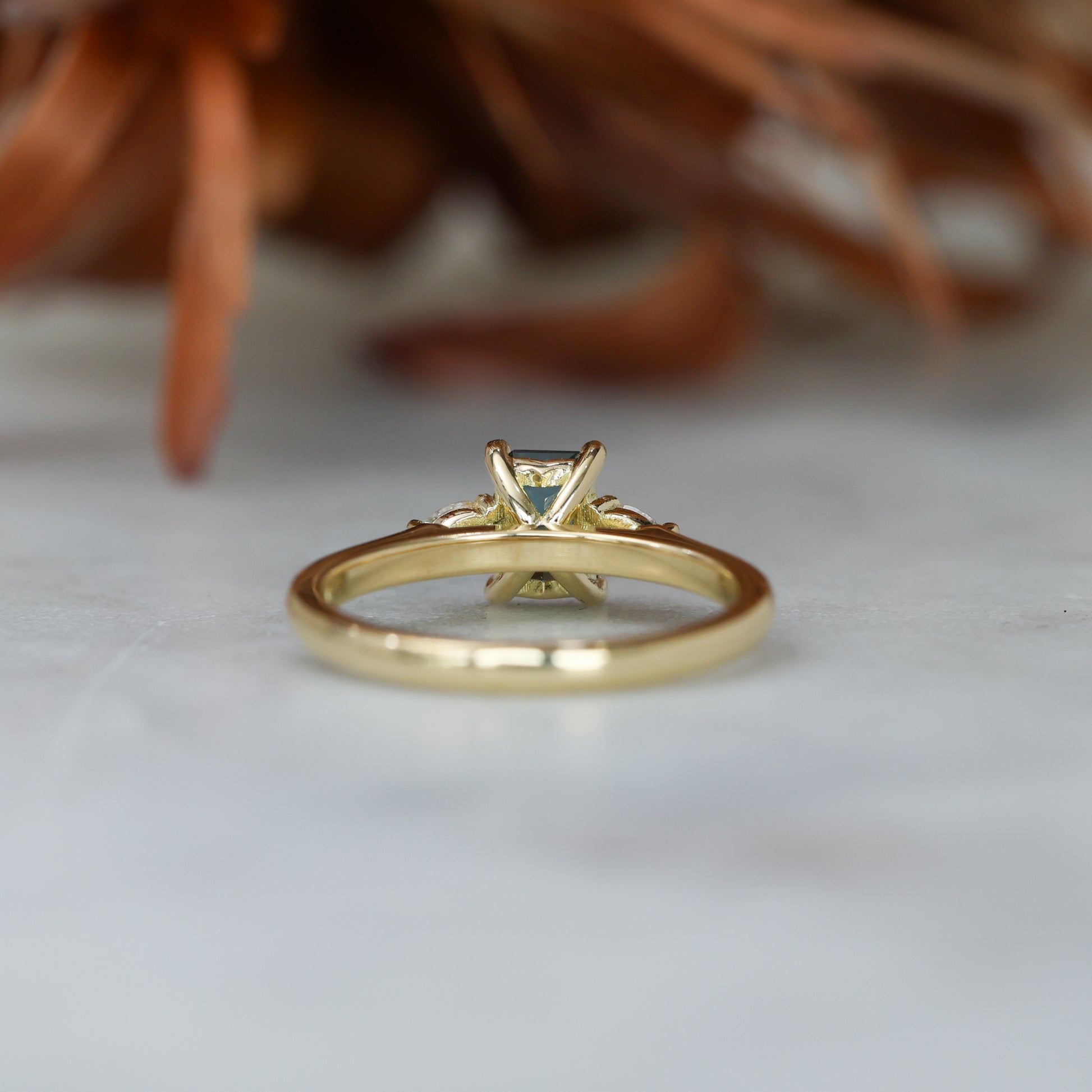 0.66ct Emerald cut australian sapphire trilogy engagement ring back