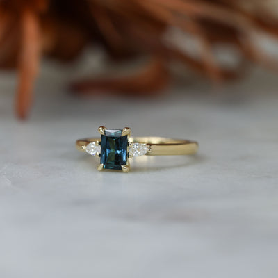 0.66ct Emerald cut australian sapphire trilogy engagement ring front side