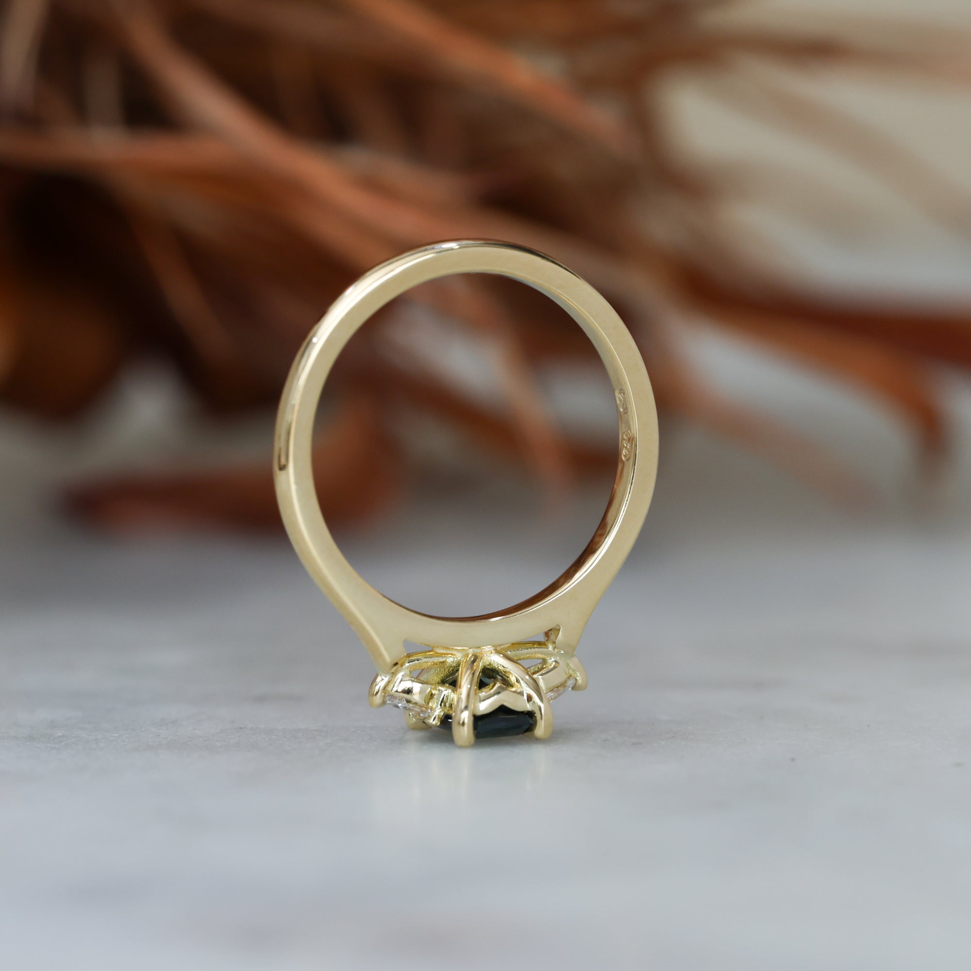 0.66ct Emerald cut australian sapphire trilogy engagement ring profile