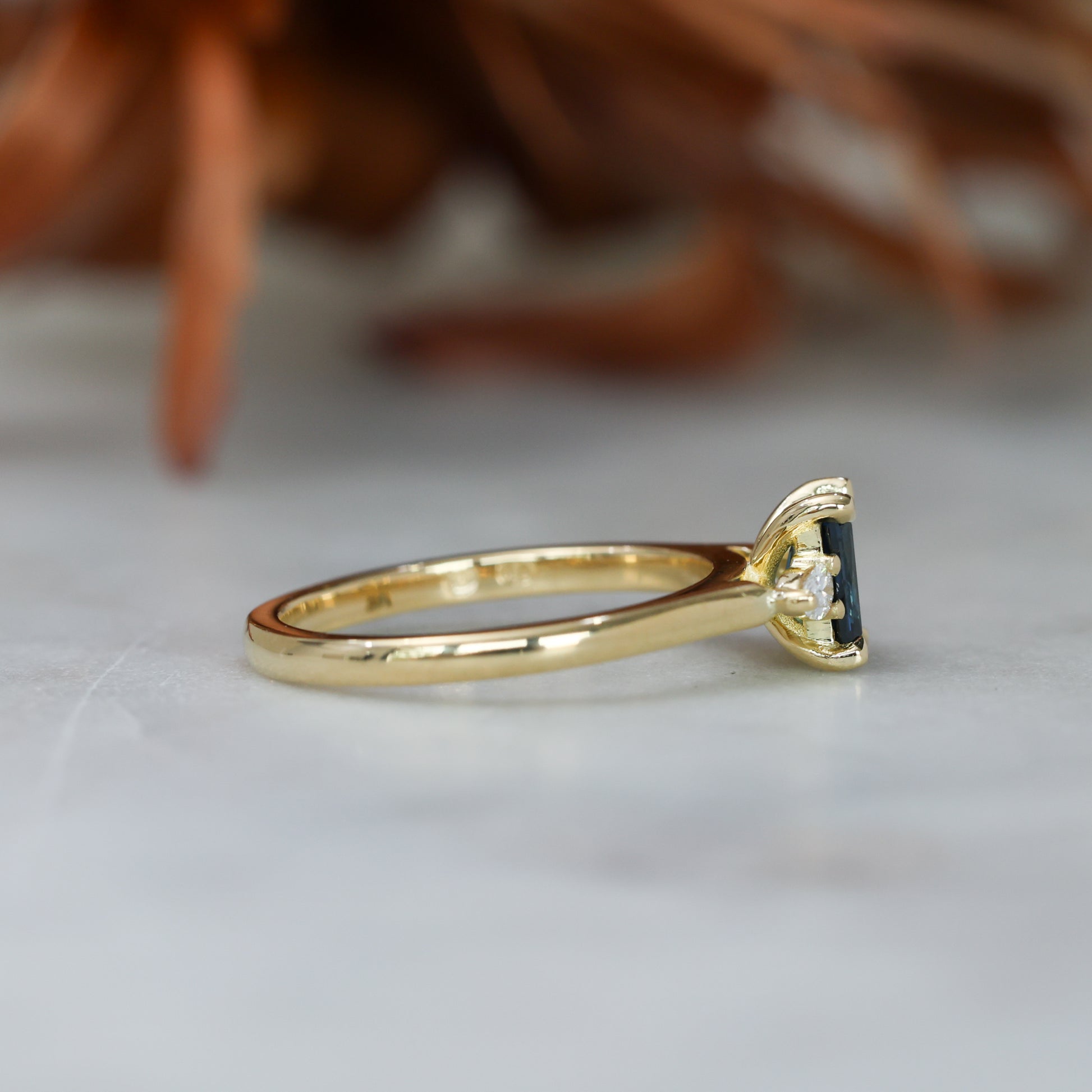 0.66ct Emerald cut australian sapphire trilogy engagement ring side