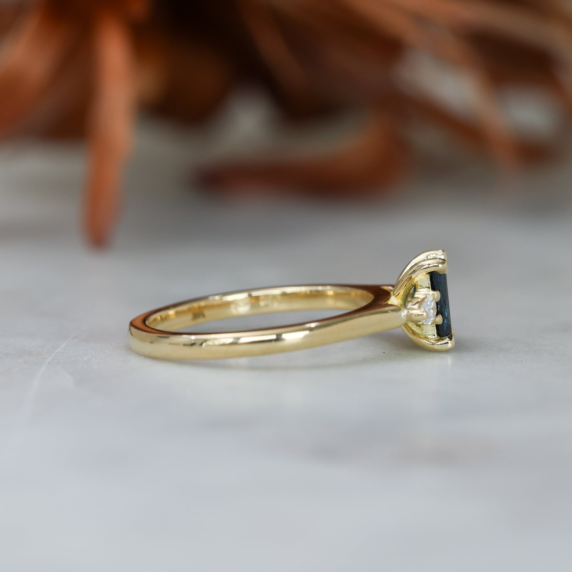 0.66ct Emerald cut australian sapphire trilogy engagement ring side