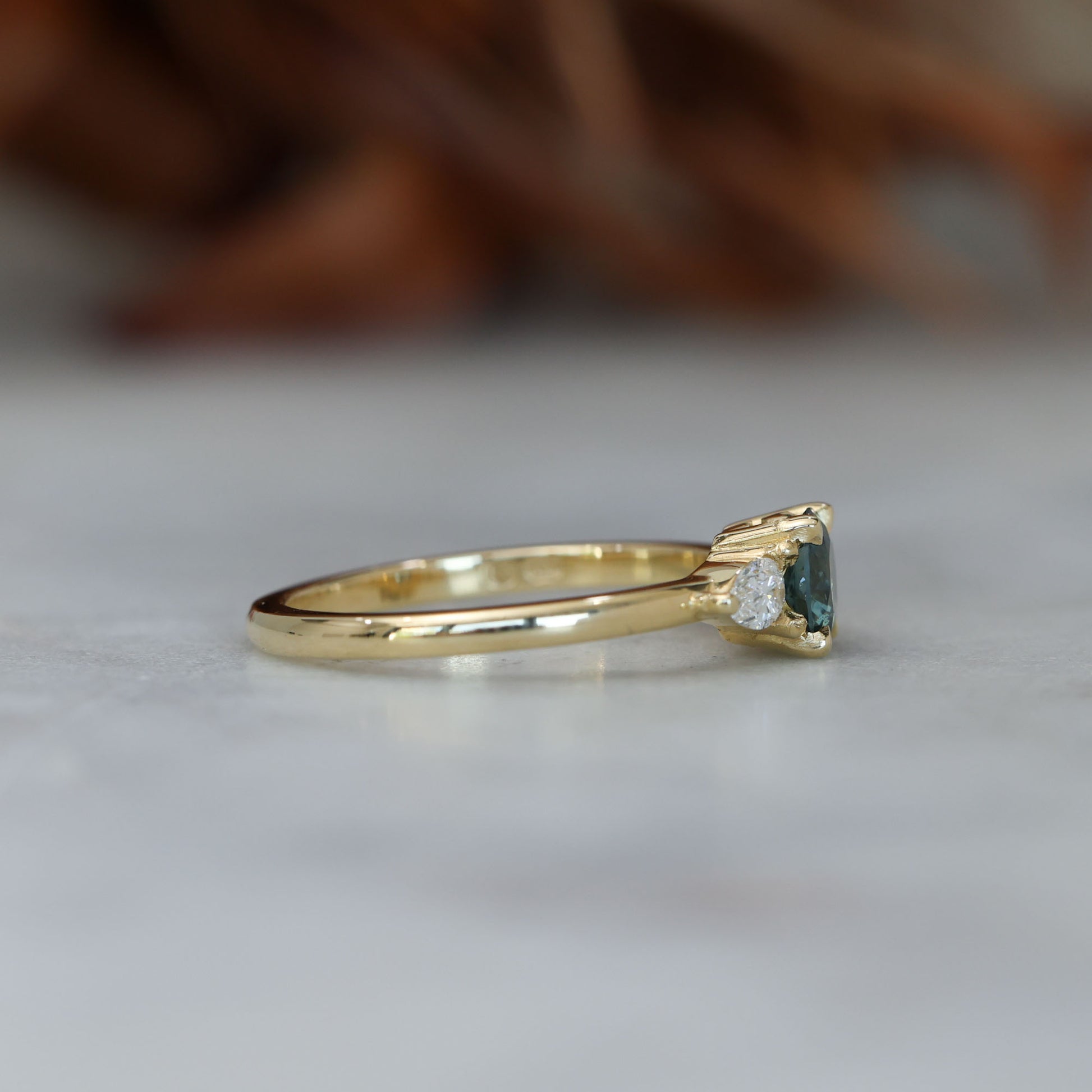 0.67ct Montana Sapphire and diamond May trilogy engagement ring side