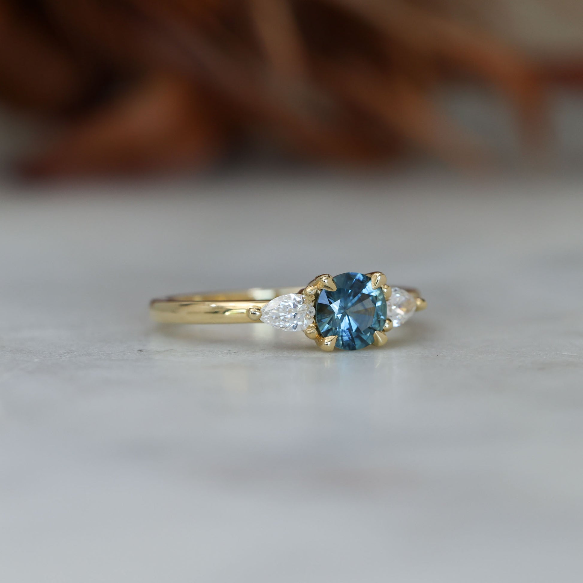 0.67ct Montana Sapphire and diamond May trilogy engagement ring side front