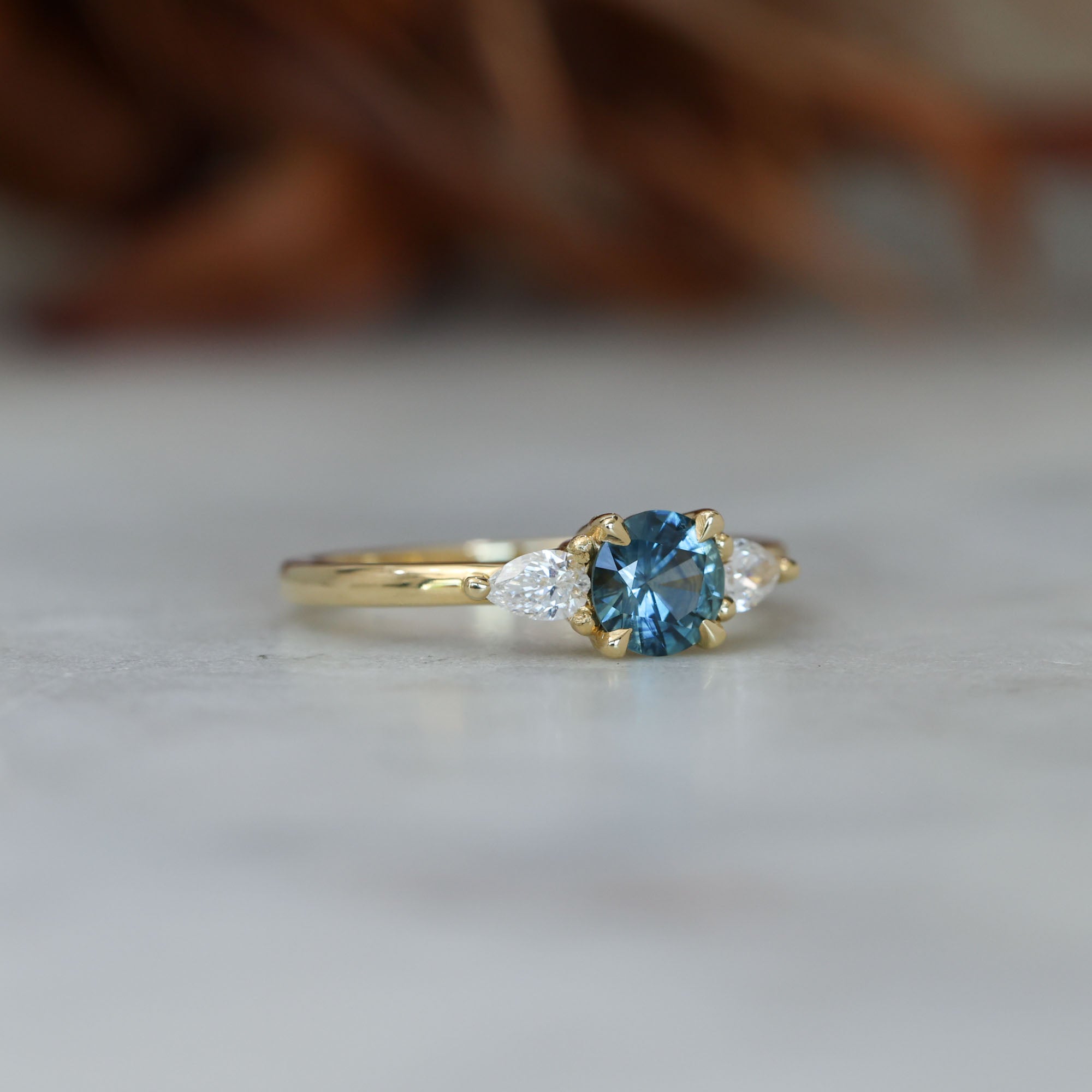 0.67ct Montana Sapphire and diamond May trilogy engagement ring side front