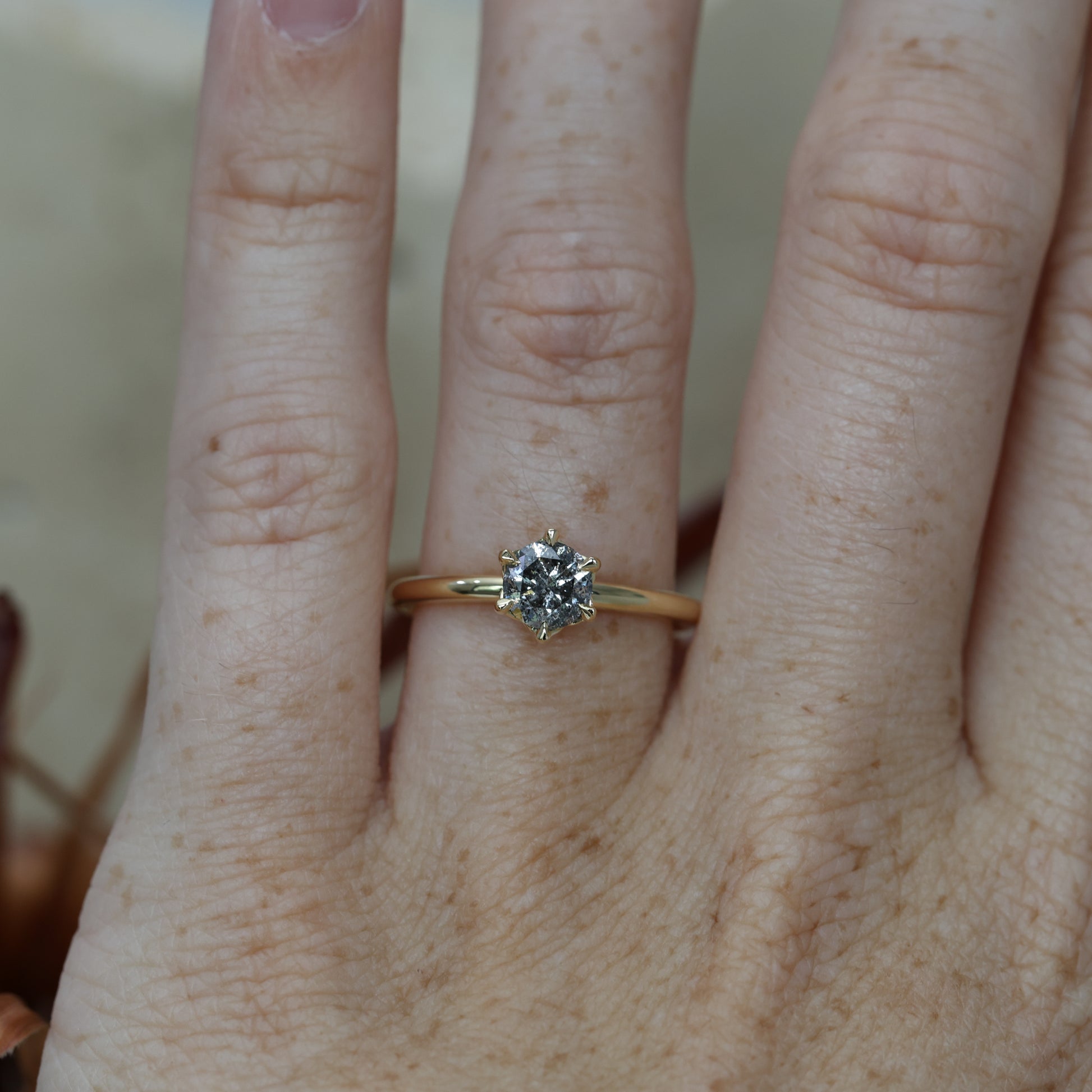 0.71ct round cut salt and pepper diamond engagement ring on hand