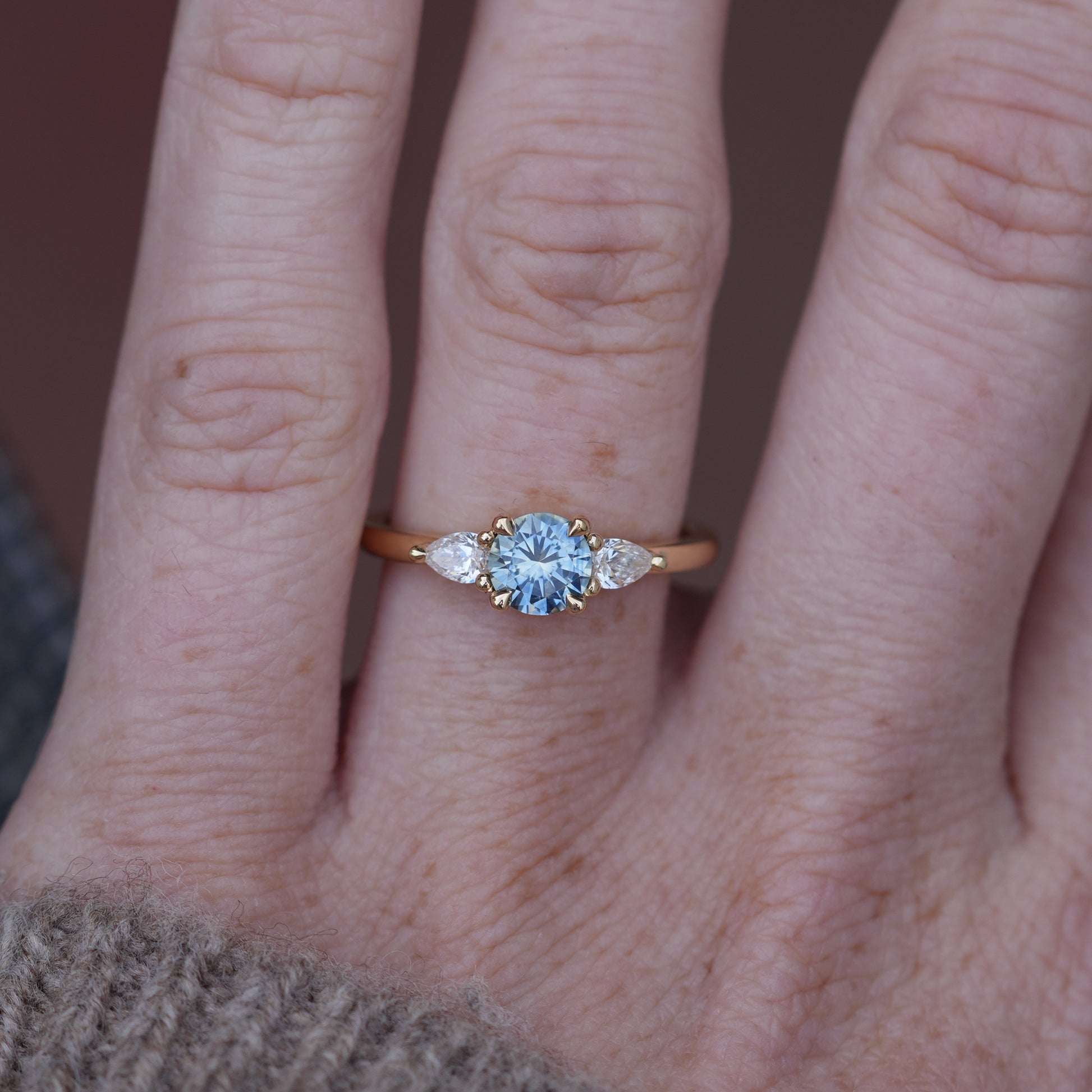 0.72ct Montana Sapphire engagement ring in yellow gold on hand
