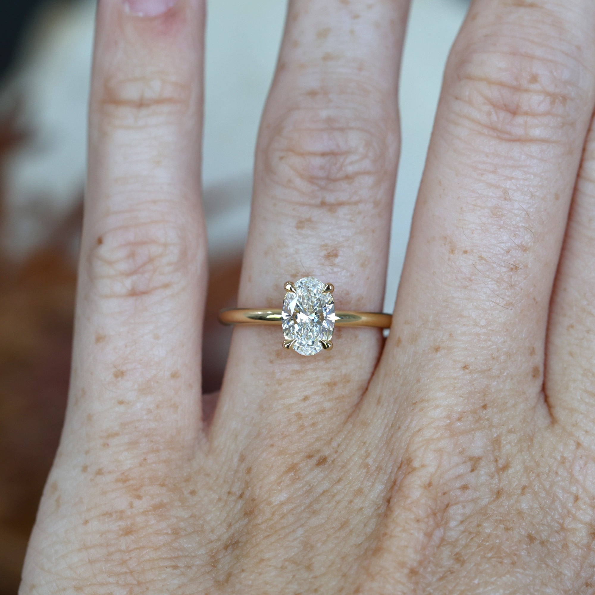 0.76ct Oval Cut Diamond Solitaire engagement ring on hand