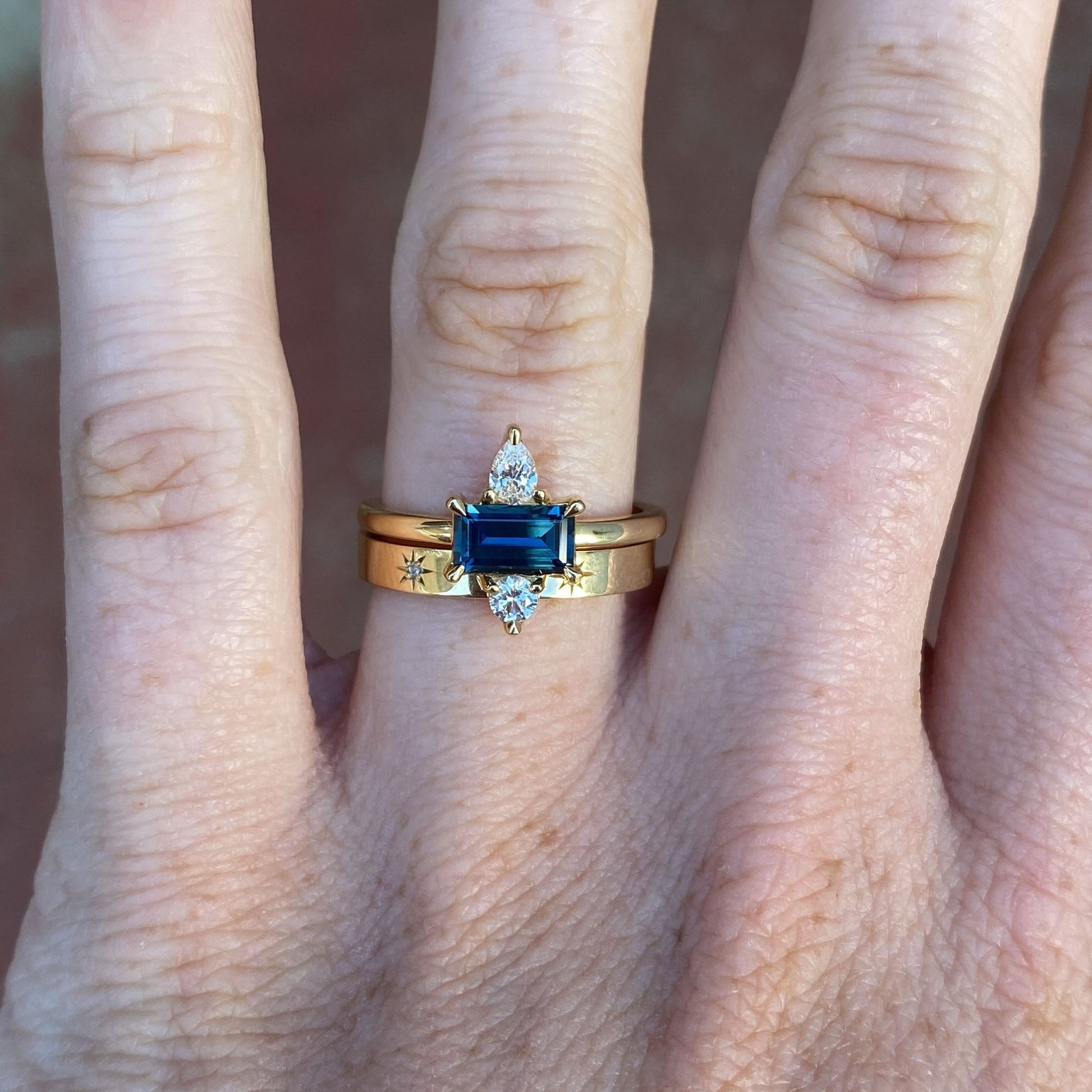 0.80ct Australian Parti Sapphire & Diamond Trio engagement ring on hand with wedding band