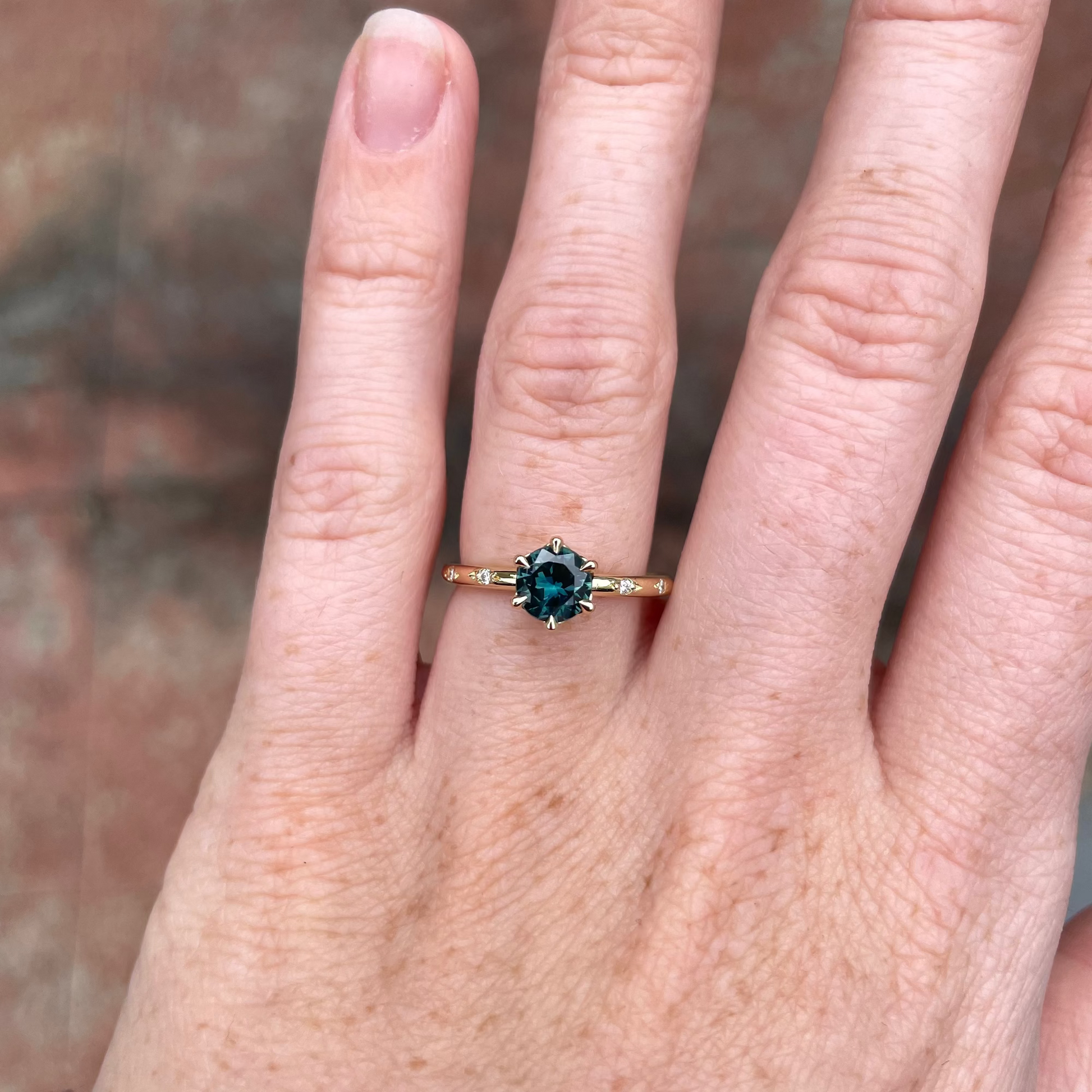 0.80ct Australian Parti Sapphire engagement ring with diamond band on hand