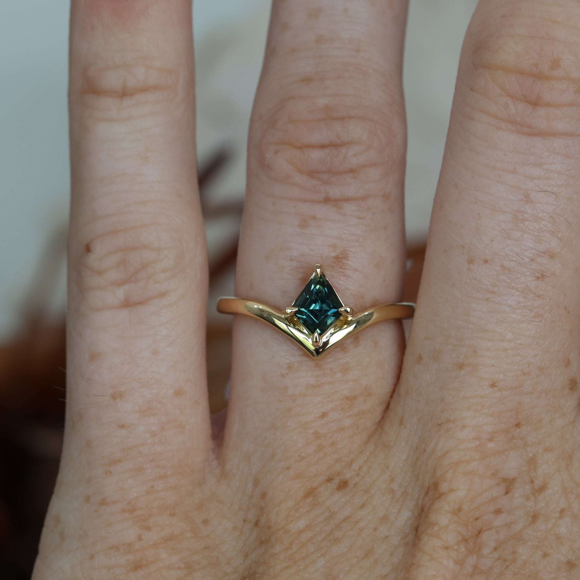 0.80ct Kite cut australian parti sapphire engagement ring on hand