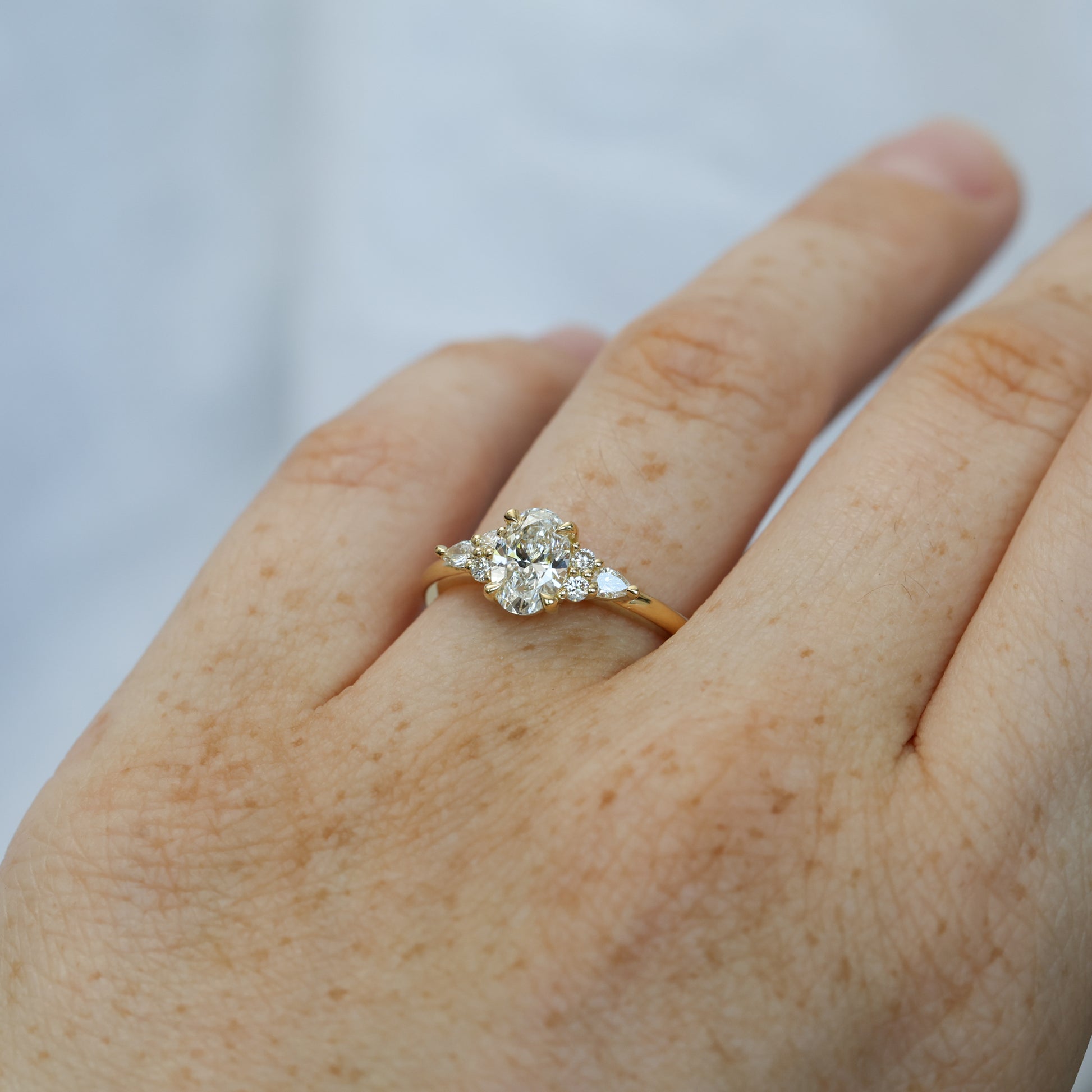 0.81ct oval cut diamond 7 stone engagement ring on hand