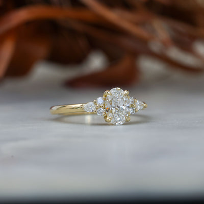 0.81ct oval cut diamond engagement ring with 6 side diamond on hand