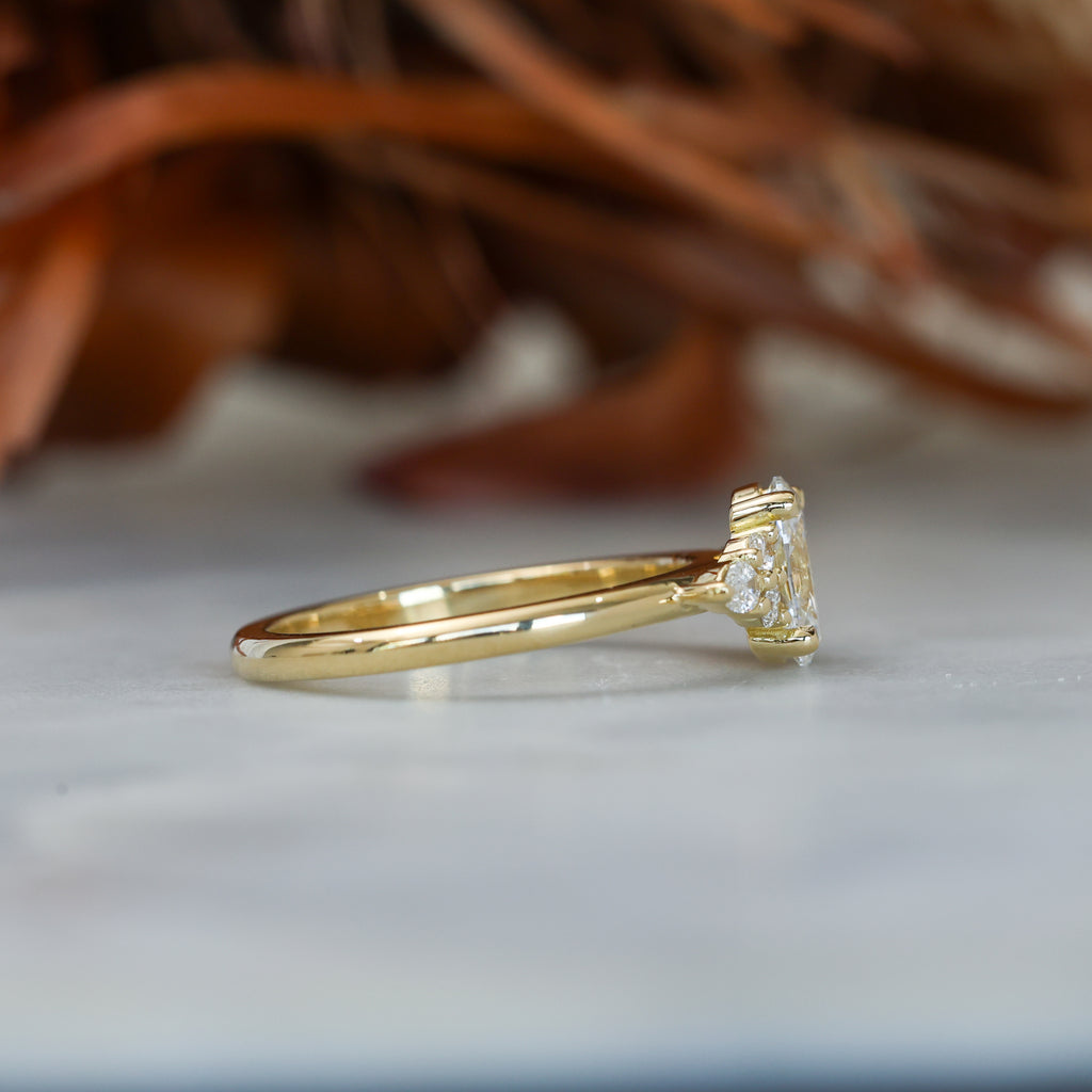 0.81ct oval cut diamond engagement ring with 6 side diamond on hand