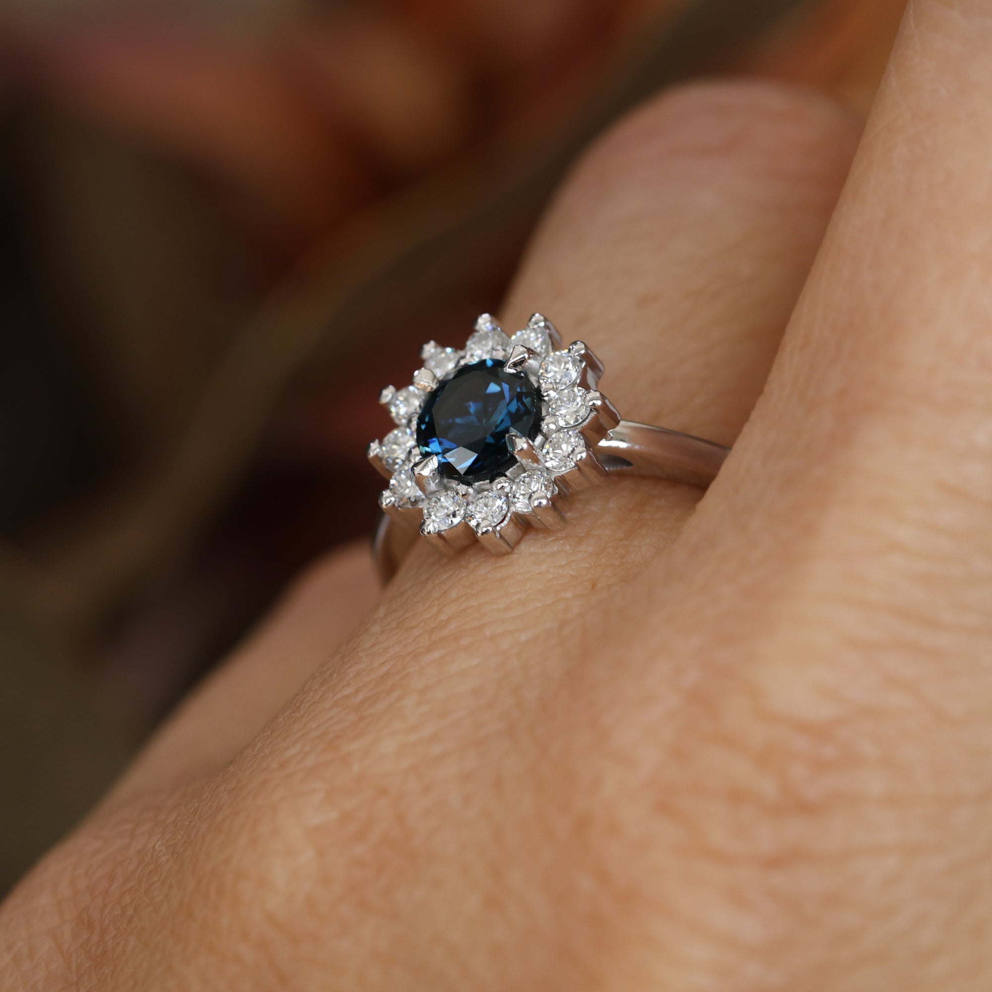 0.82ct Australian Parti Sapphire full diamond halo engagement ring on hand profile view
