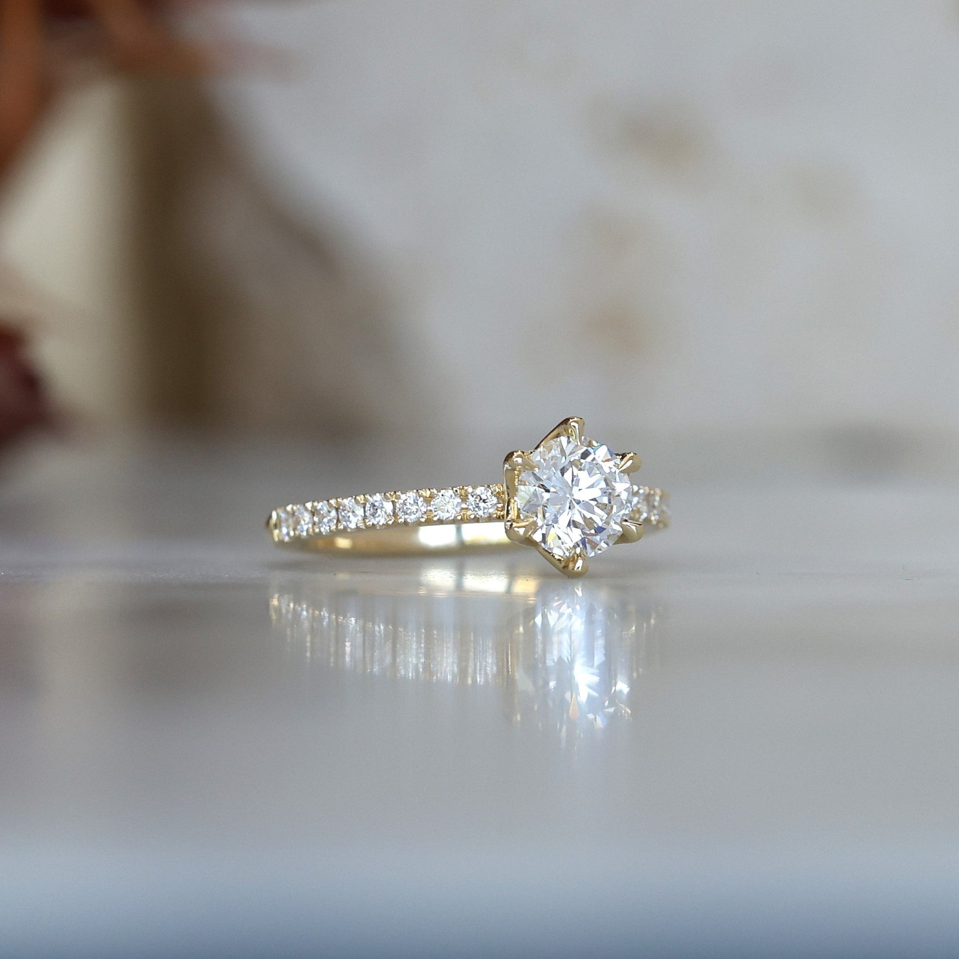 0.82ct round cut diamond engagement ring with diamond pave band