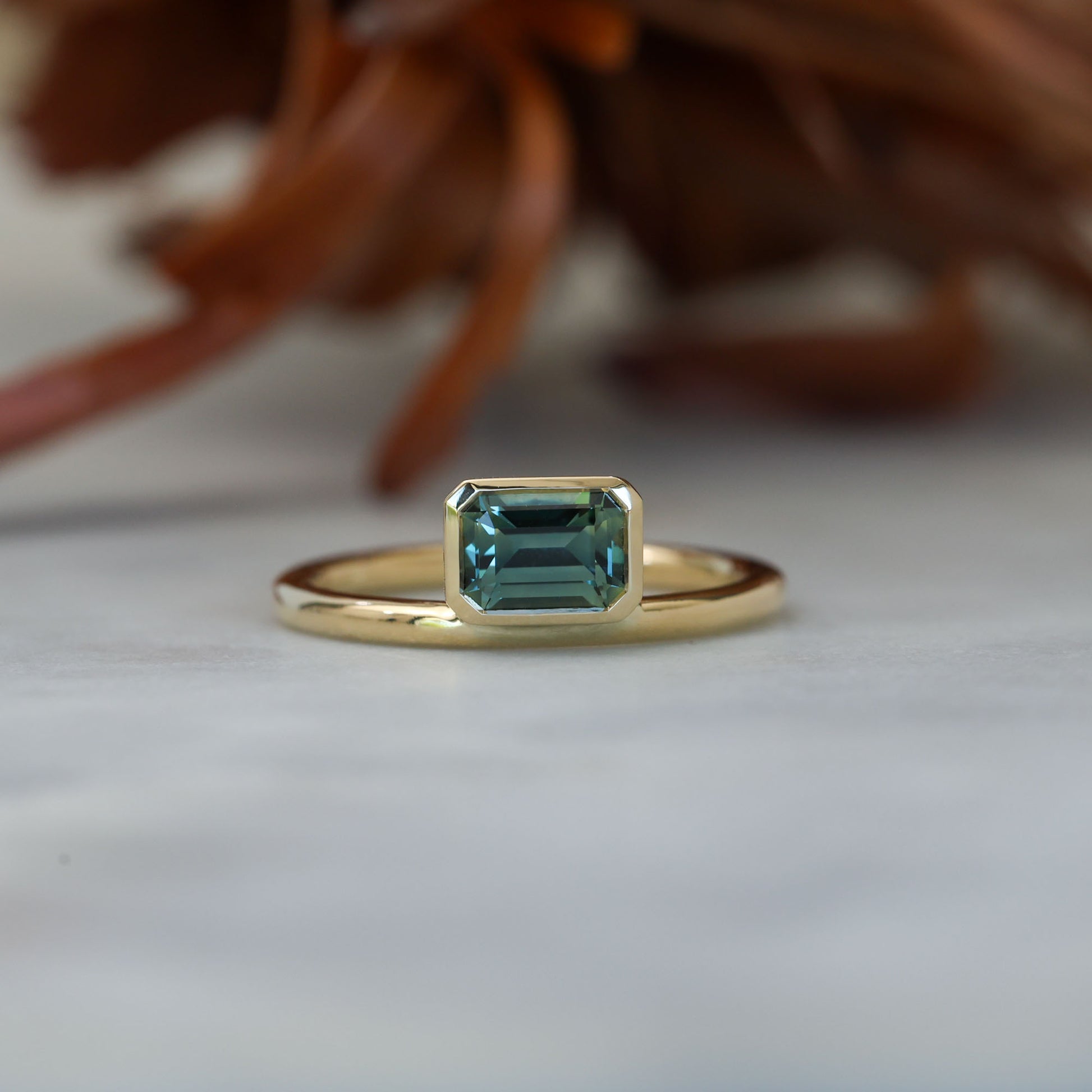 0.84ct emerald cut australian parti sapphire offset bezel engagement ring