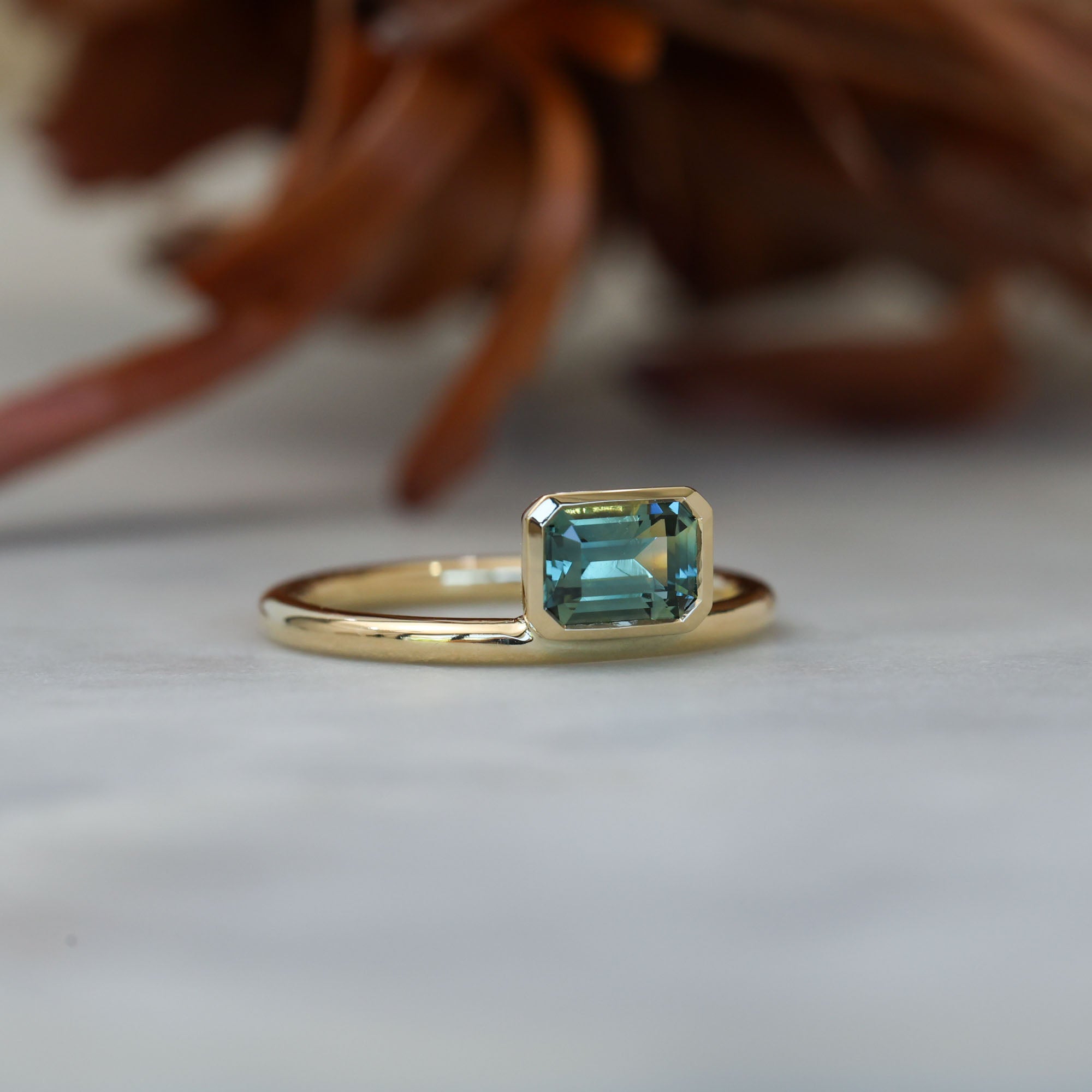 0.84ct emerald cut australian parti sapphire offset bezel engagement ring