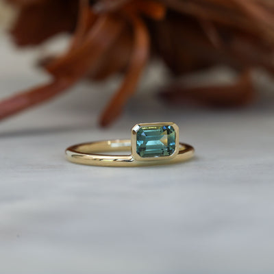 0.84ct emerald cut australian parti sapphire offset bezel engagement ring