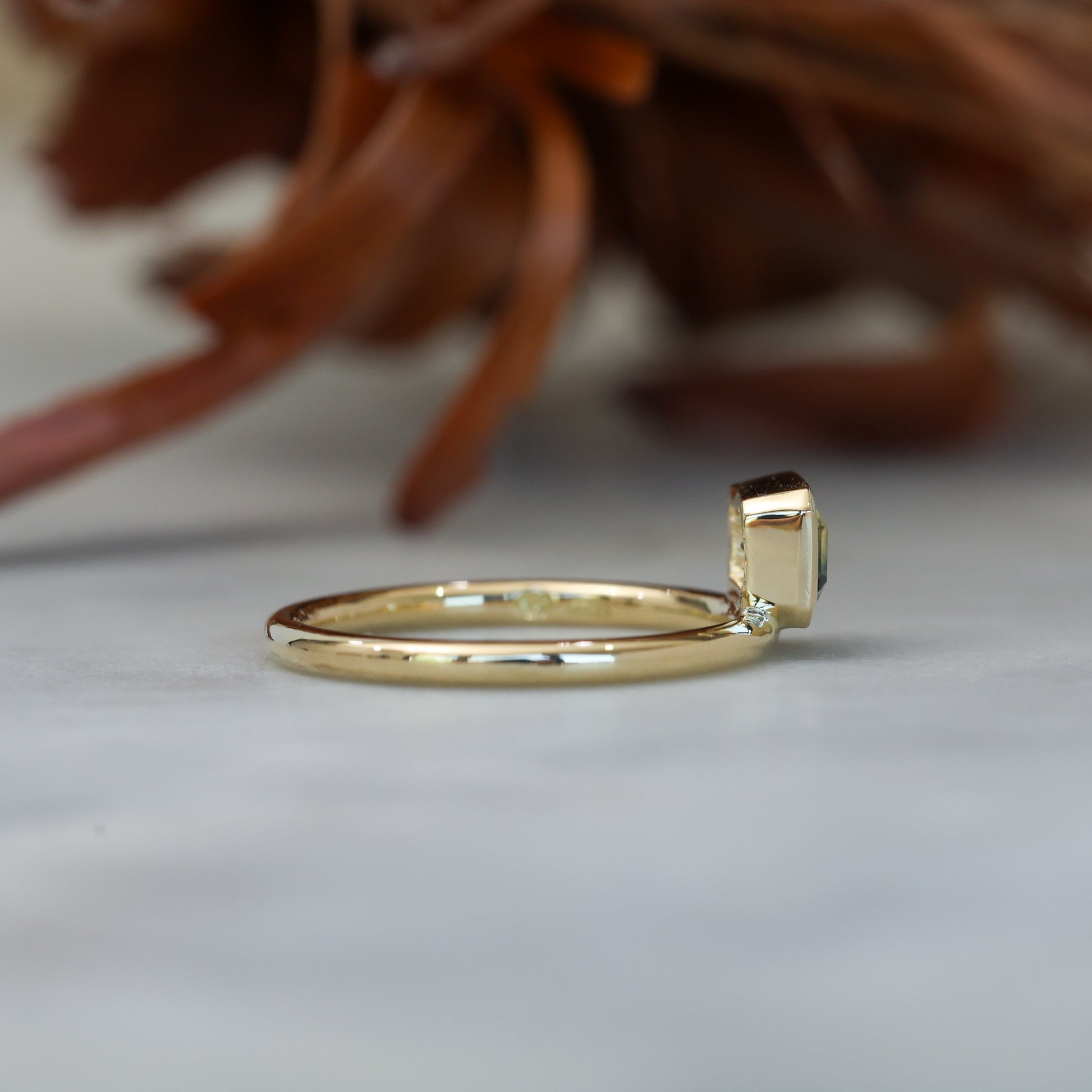 0.84ct emerald cut australian parti sapphire offset bezel engagement ring side