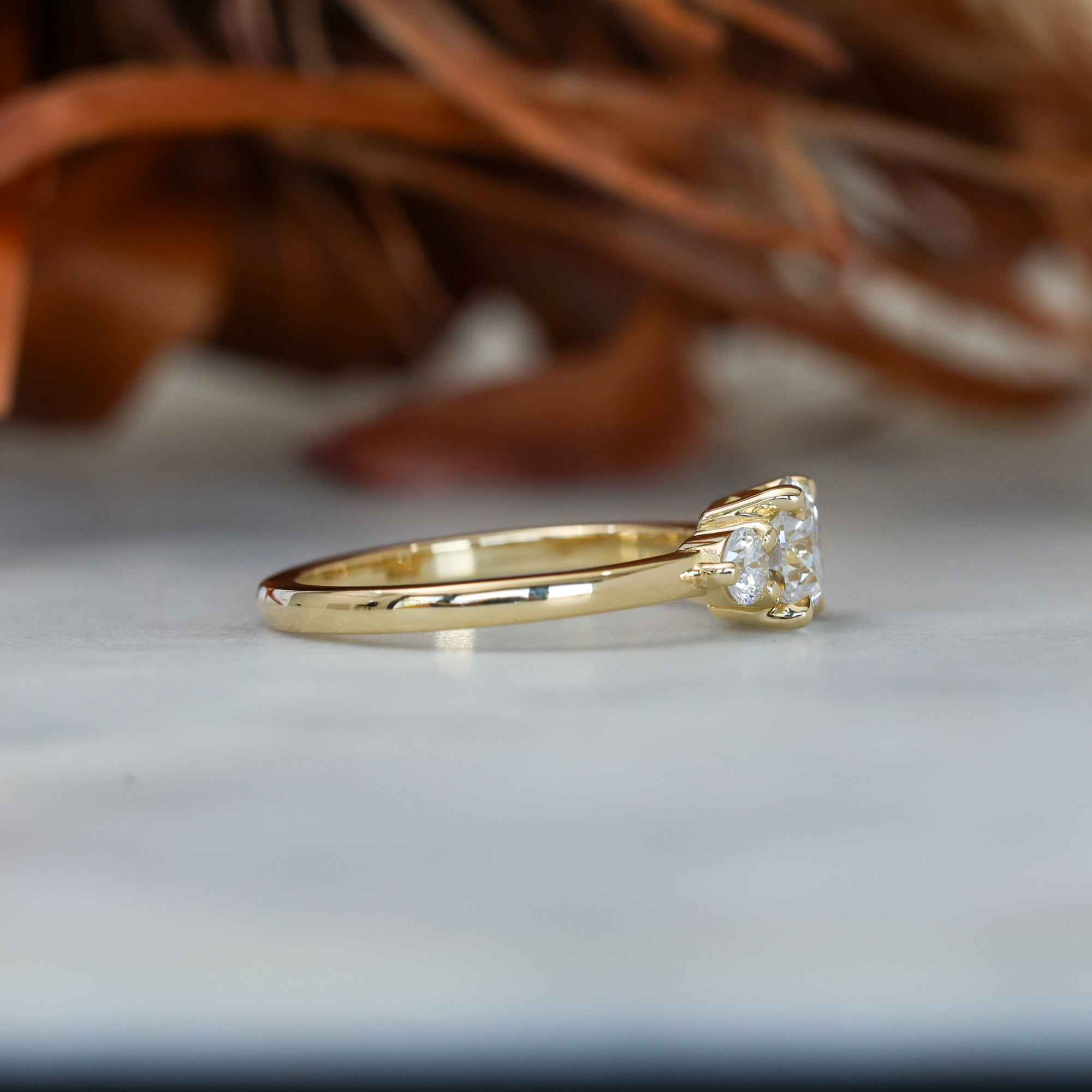 0.84ct round cut diamond trilogy engagement ring side