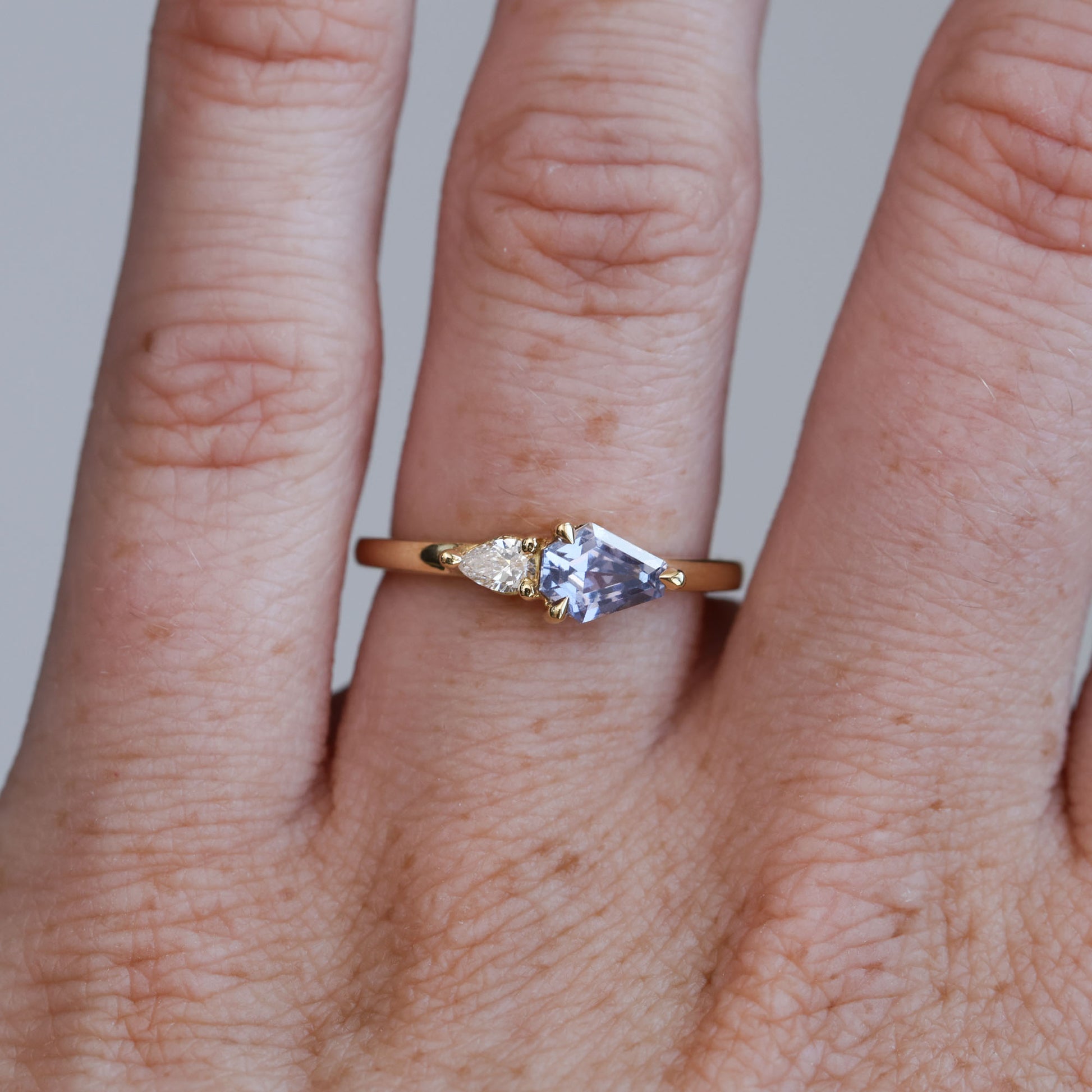 0.85ct Madagascan Sapphire & diamond engagement ring on hand
