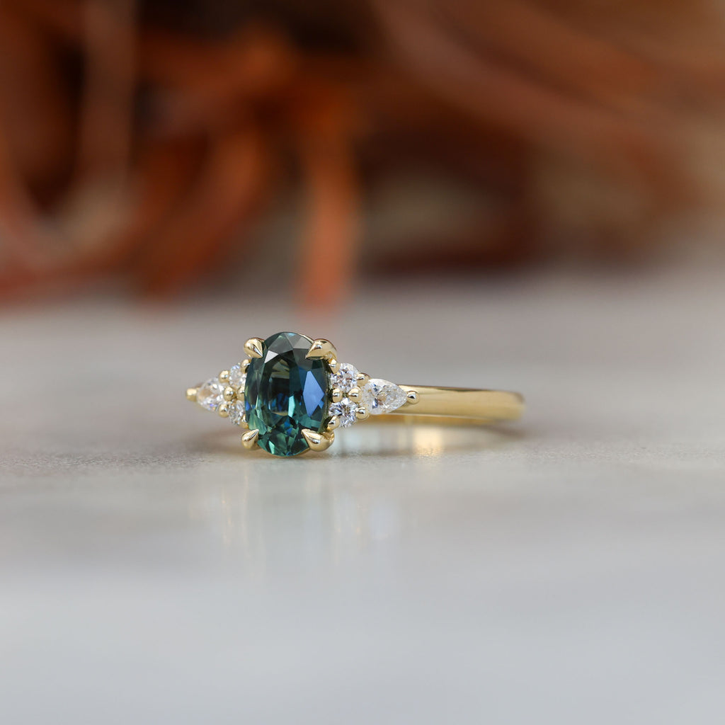 0.93ct oval cut Australian Sapphire and diamond engagement ring in yellow gold