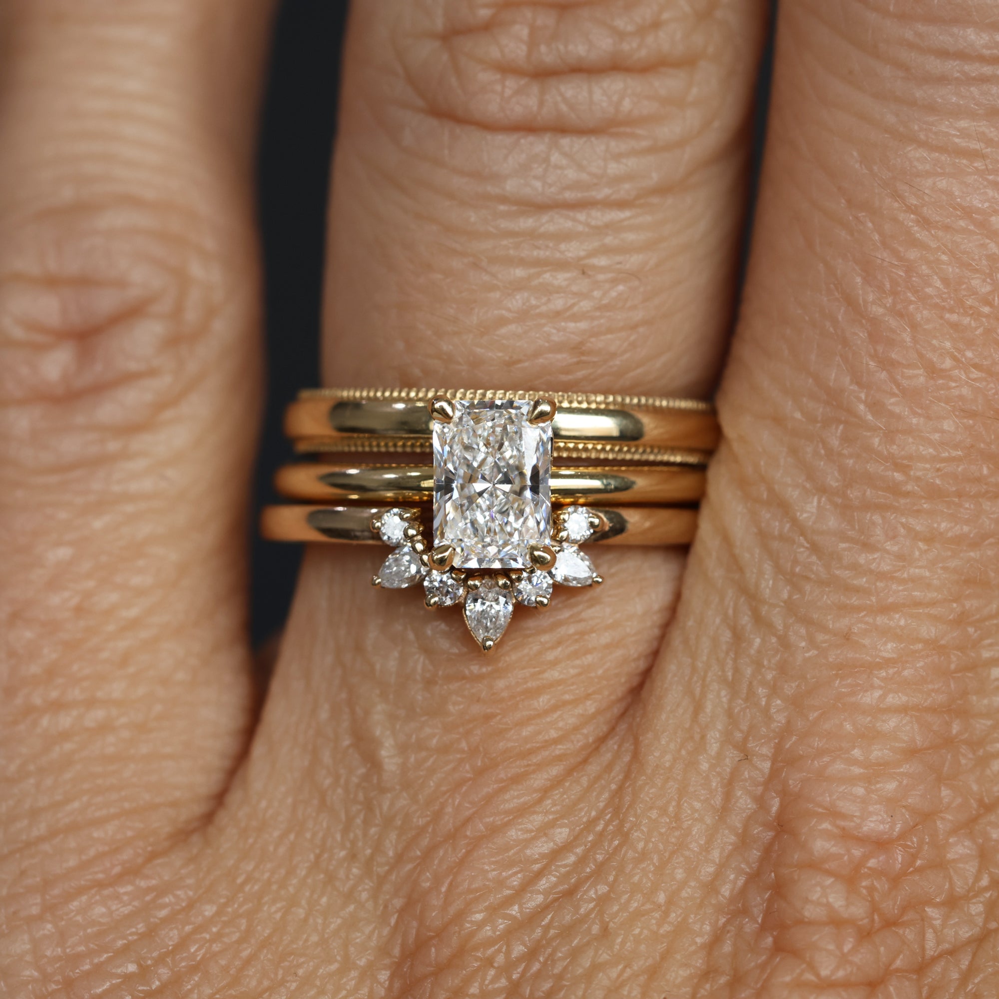 1.00ct Radiant Cut Diamond Solitaire engagement ring with wedding bands on hand