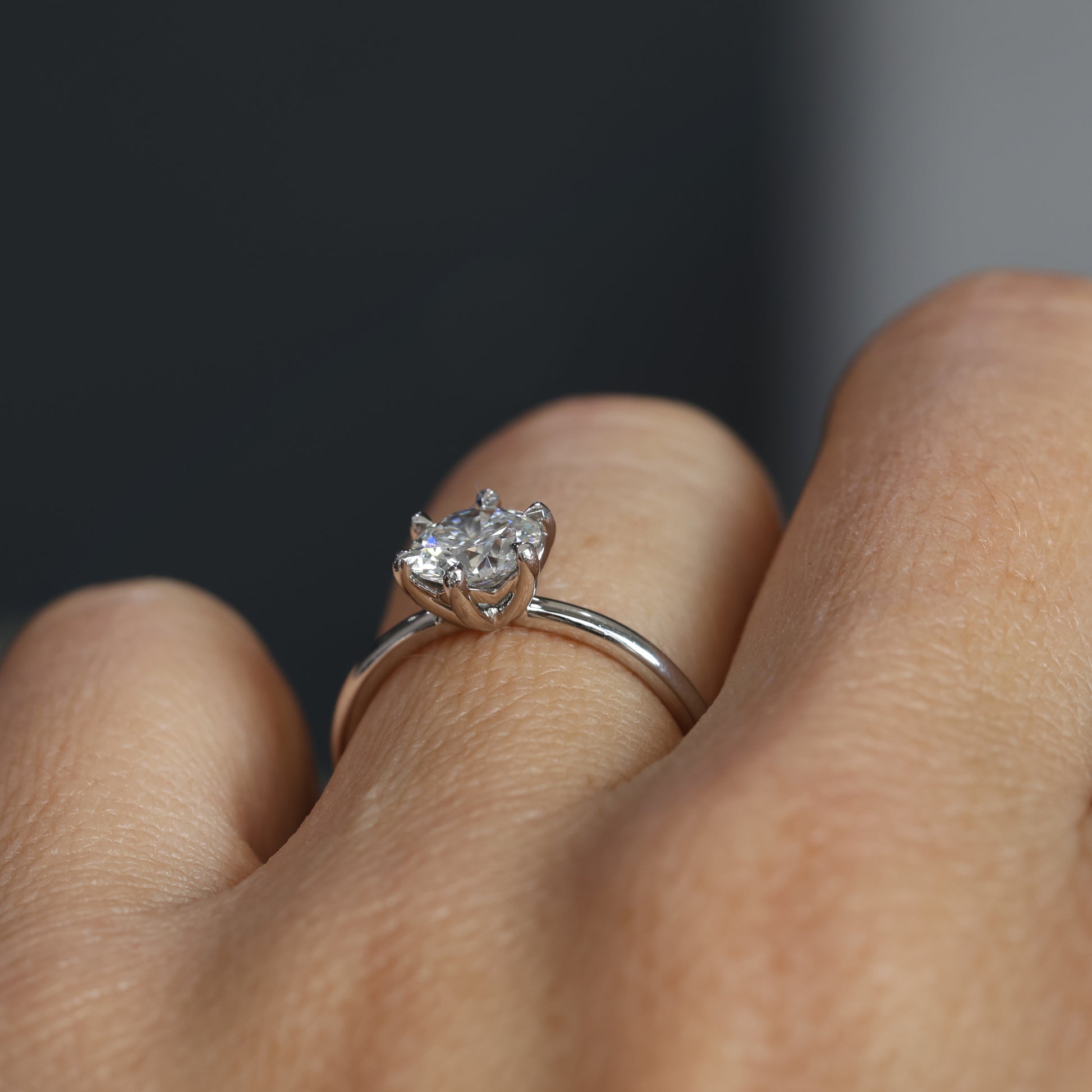 1.00ct round cut diamond solitaire engagement ring on hand