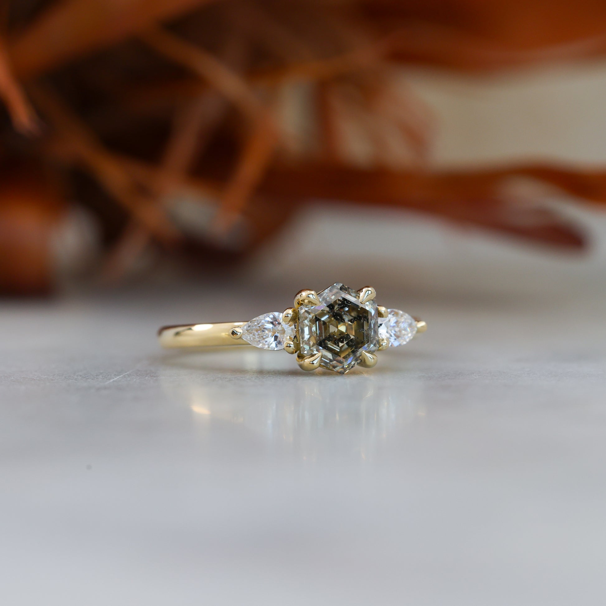 natural hexagon cut salt and pepper champagne diamond trilogy engagement ring yellow gold
