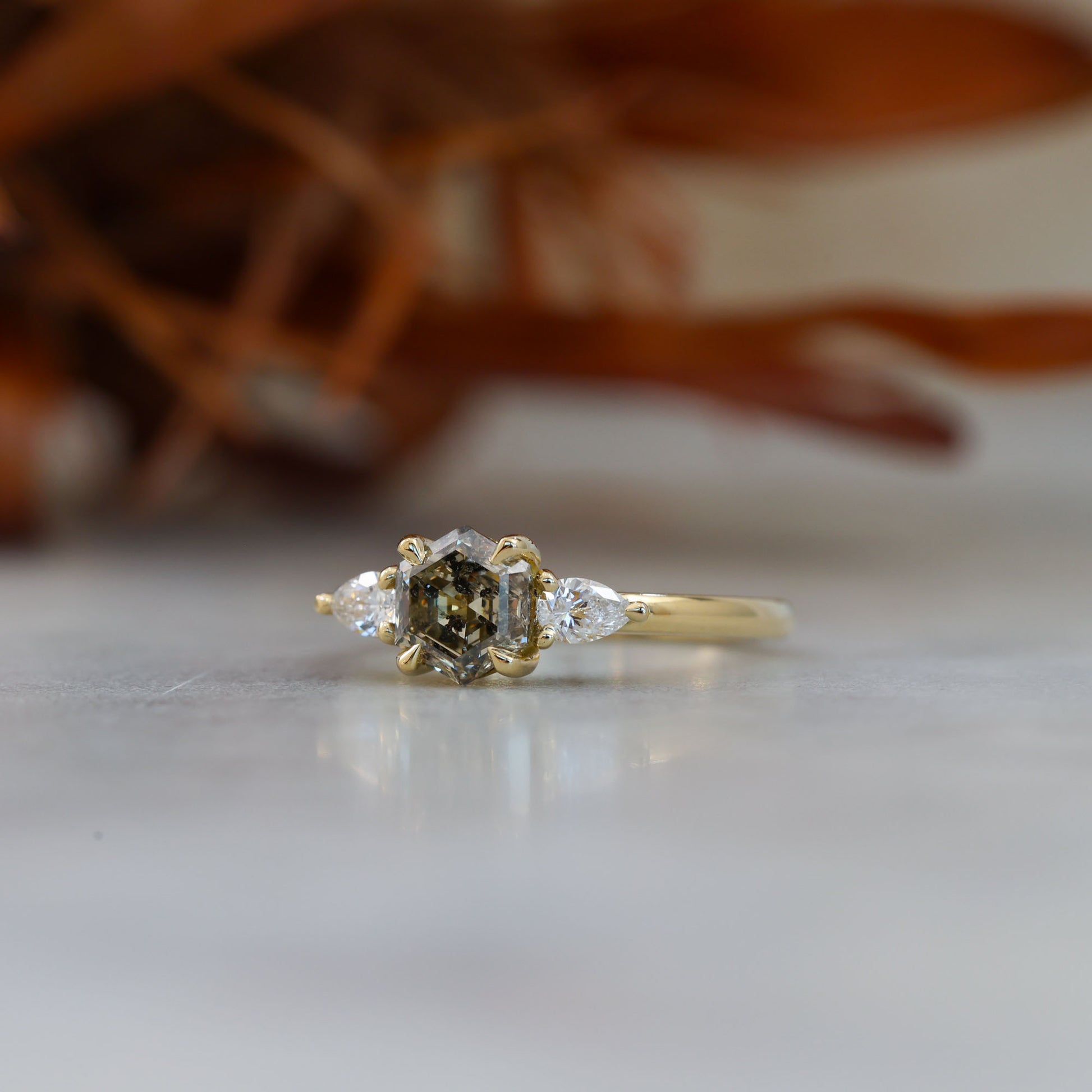 natural hexagon cut salt and pepper champagne diamond trilogy engagement ring yellow gold