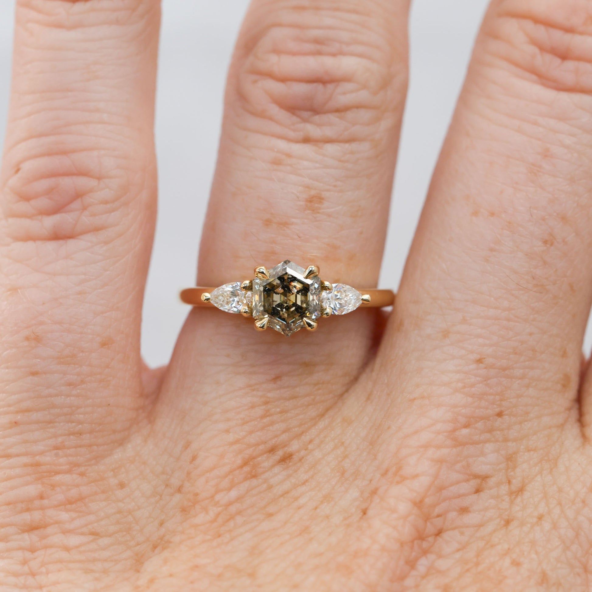 natural hexagon cut salt and pepper champagne diamond trilogy engagement ring yellow gold