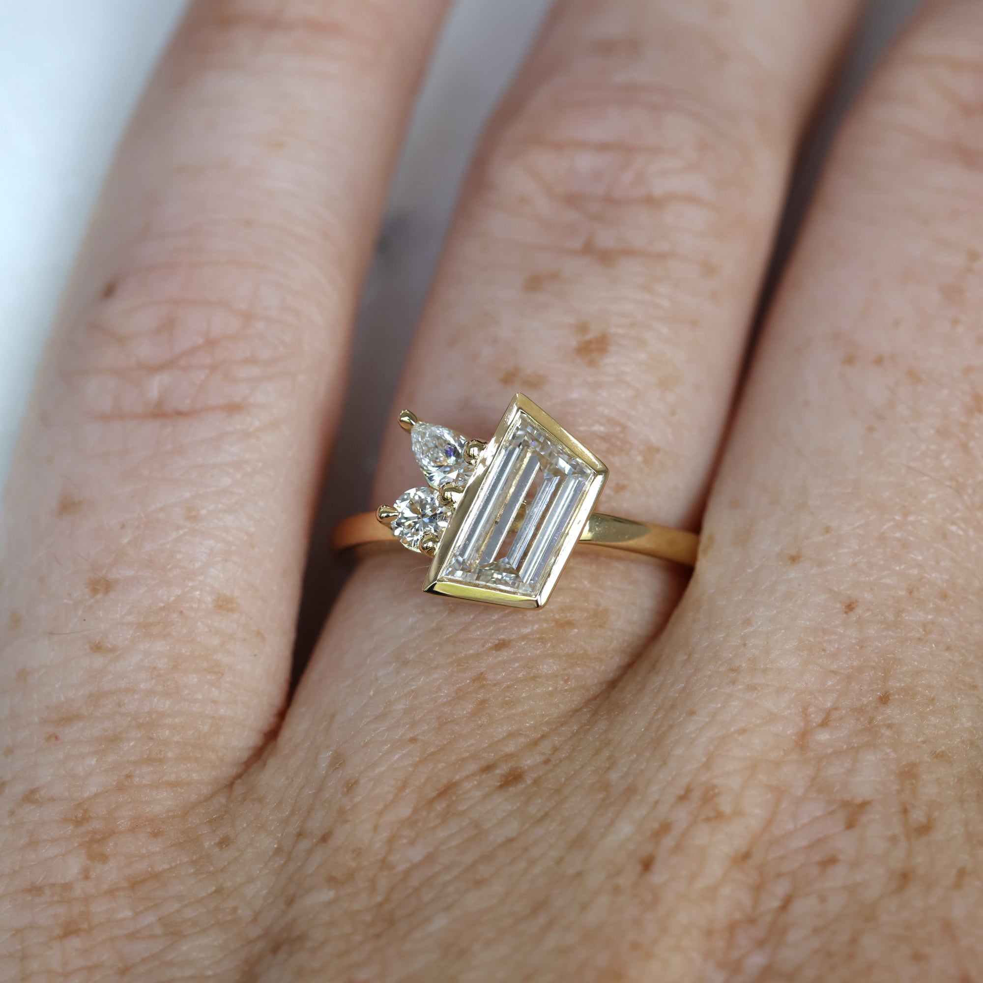 1.02ct Trapeze cut diamond Bezel Set Engagement ring on hand