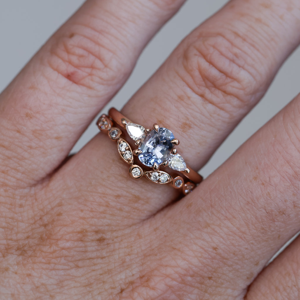 1.06ct Oval cut madagascan sapphire engagement ring on hand with wedding band