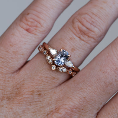 1.06ct Oval cut madagascan sapphire engagement ring on hand with wedding band