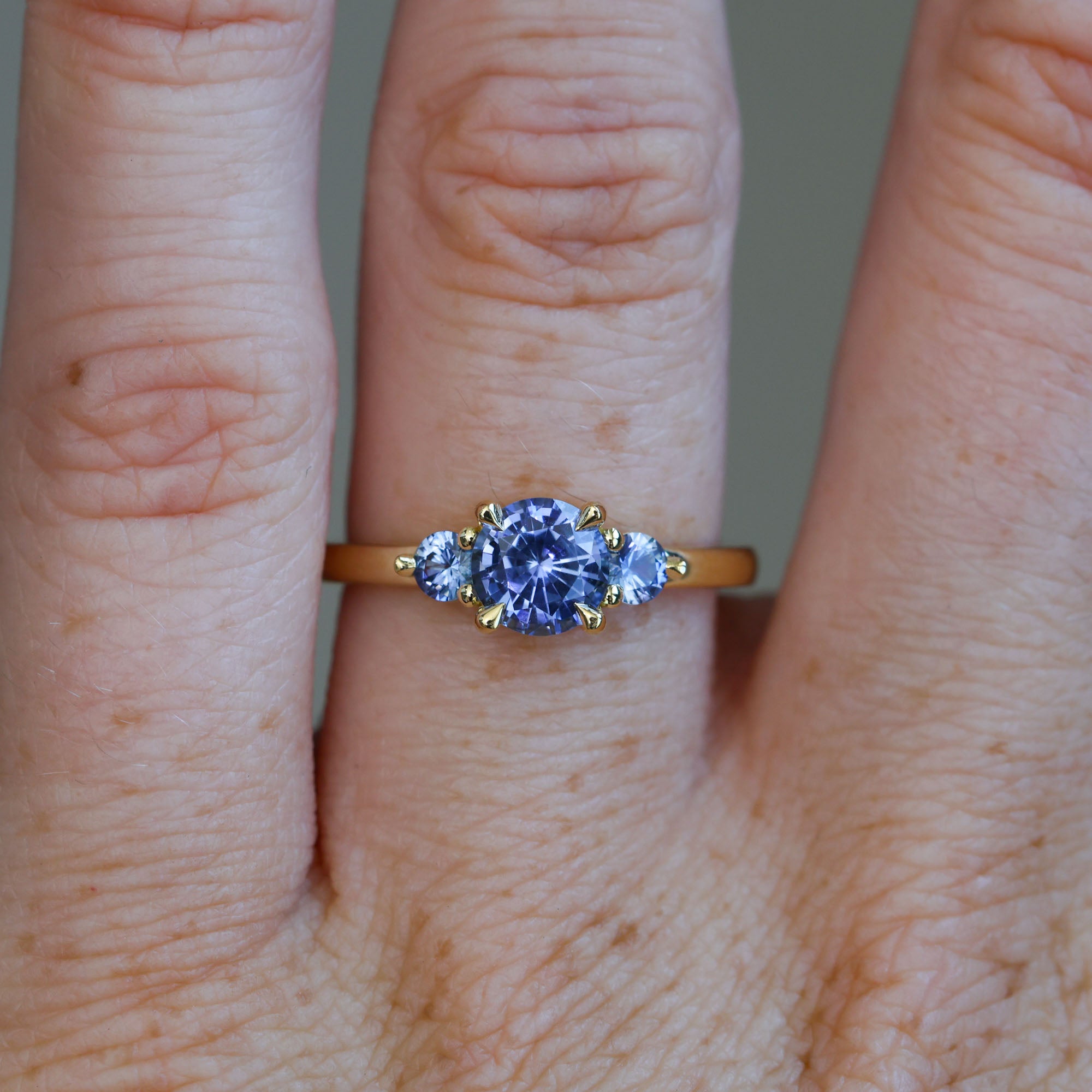 1.07ct ceylon sapphire triple lunar trilogy engagement ring on hand